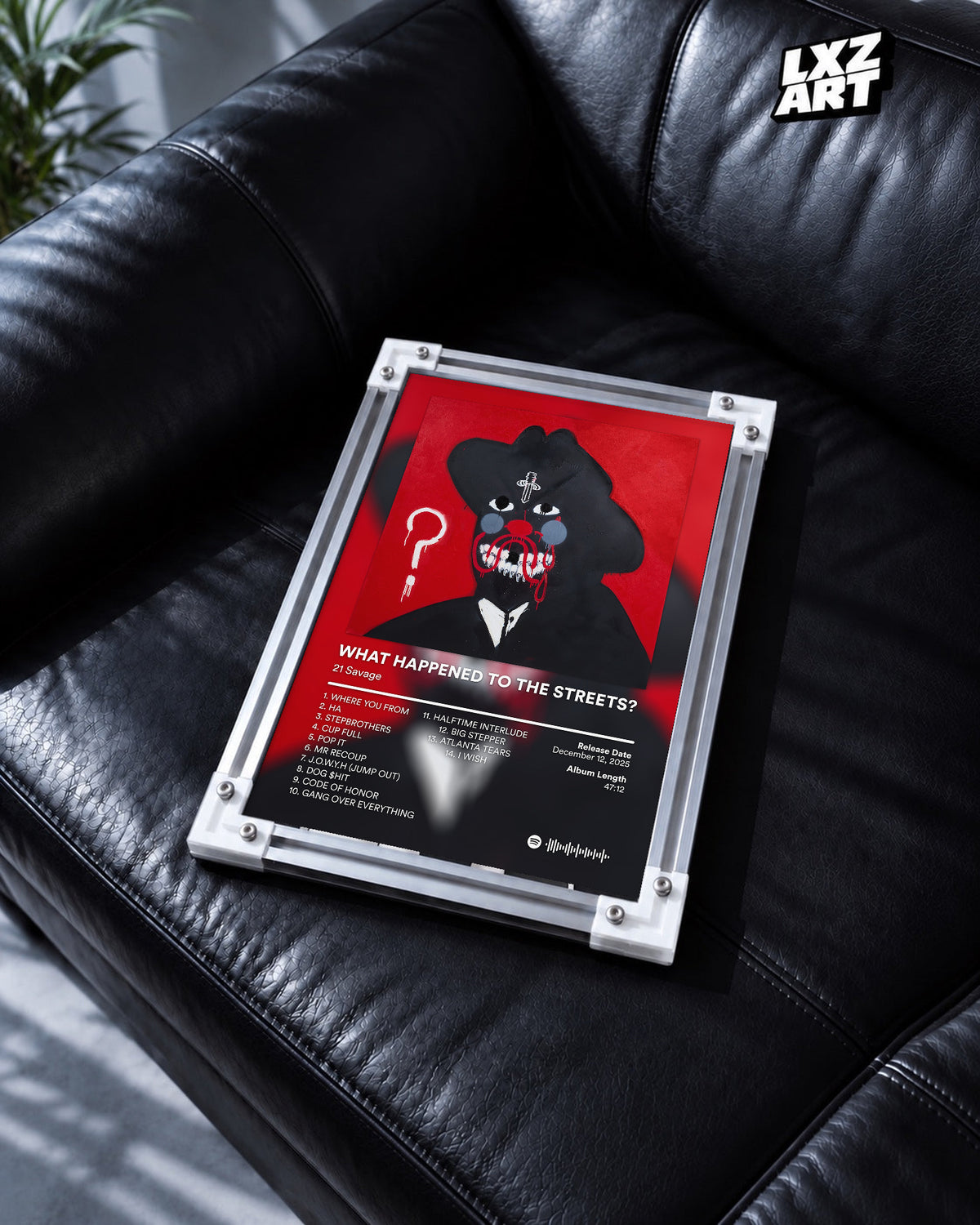 21 Savage What Happened to the Streets? Red Tracklist Poster | Unframed Wall Art shown on a black leather sofa; frame not included.