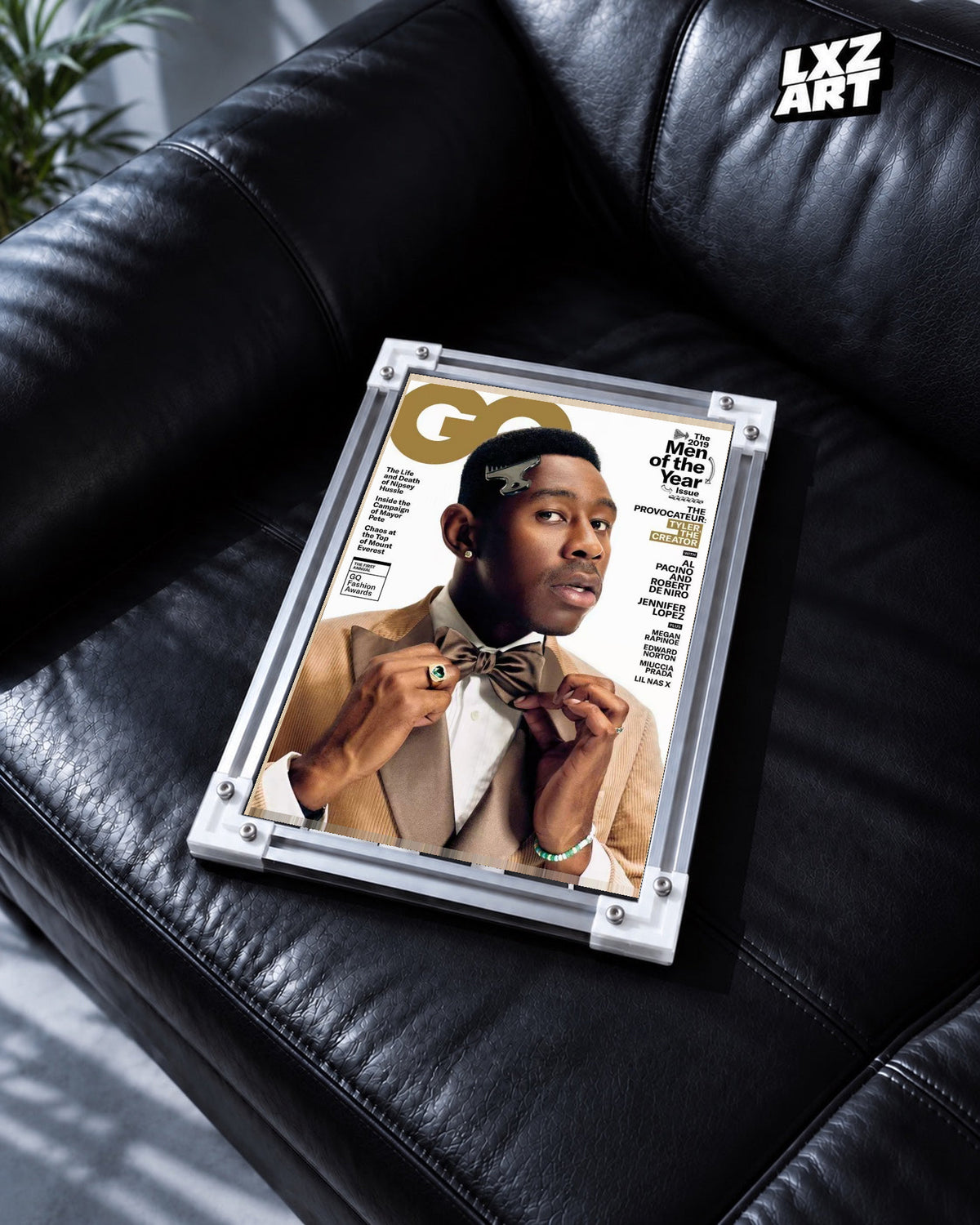Tyler, The Creator Fashion Portrait Poster in white-corner frame on black leather sofa. Frame shown for display only.