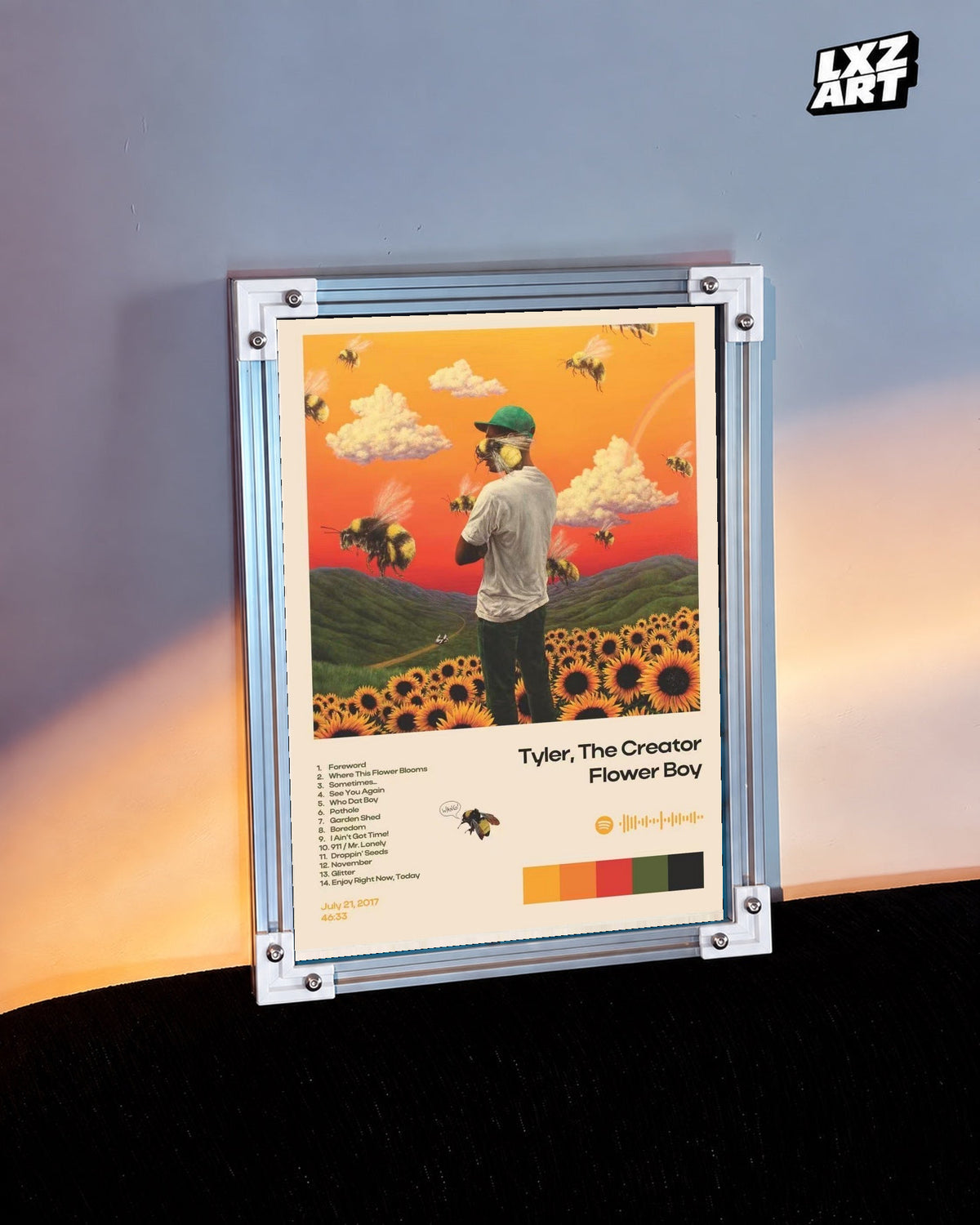 Tyler, The Creator Flower Boy Tracklist Poster in white-corner frame on warm-lit wall. Frame shown for display only.