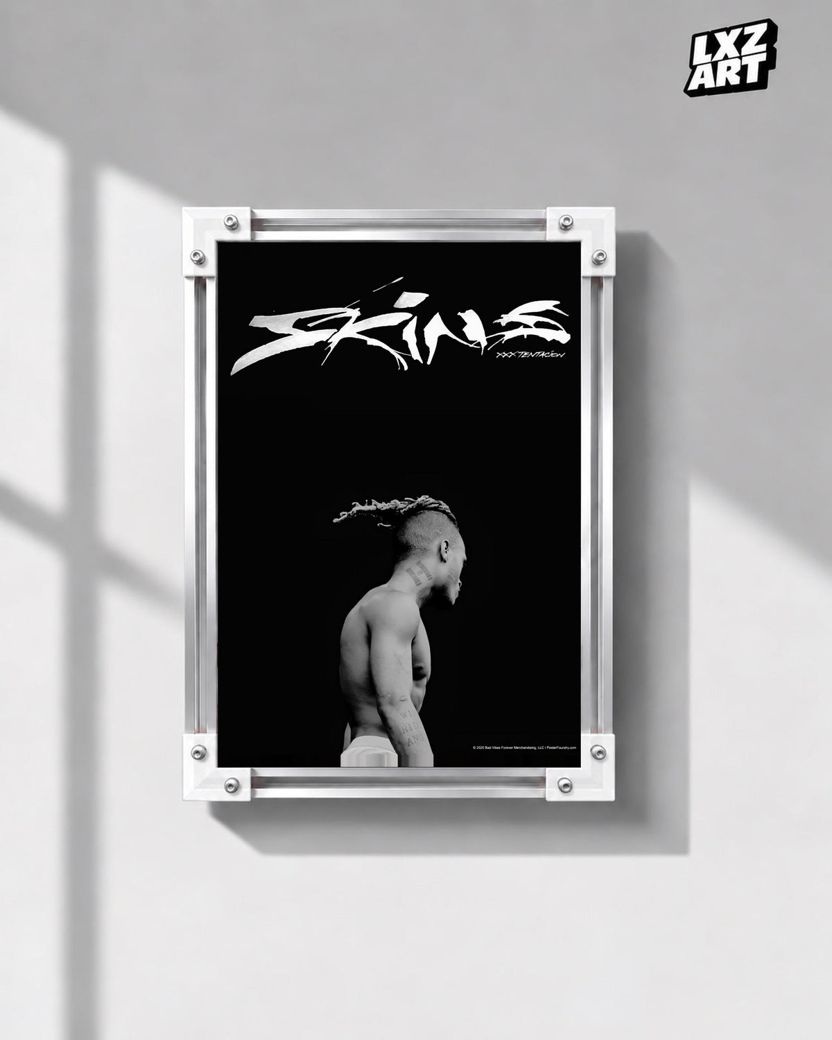 XXXTentacion Skins Minimal Black Poster in white-corner frame on gray wall. Frame shown for display only.