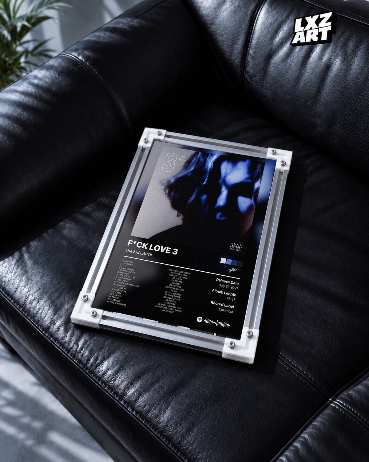 The Kid LAROI FLV3 Tracklist Poster in white-corner frame on black leather sofa. Frame shown for display only.