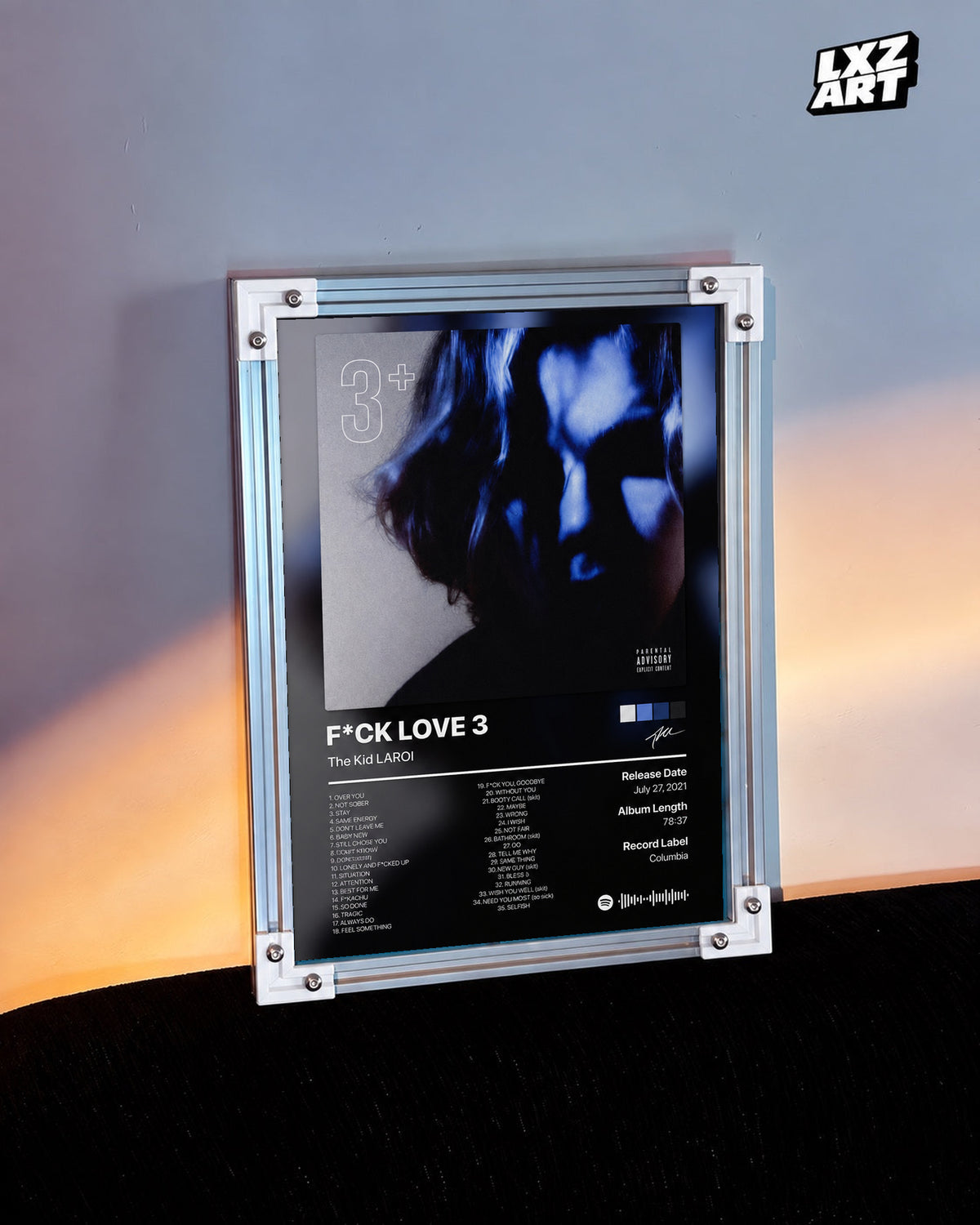 The Kid LAROI FLV3 Tracklist Poster in white-corner frame on warm-lit wall. Frame shown for display only.