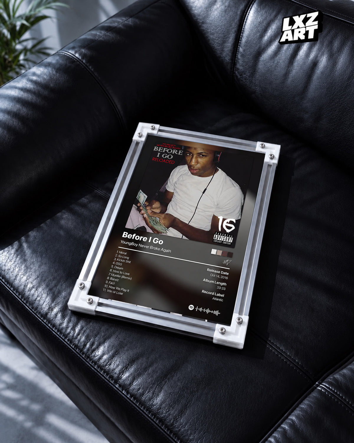 YoungBoy Never Broke Again Before I Go Tracklist Poster in white-corner frame on black leather sofa. Frame shown for display only.