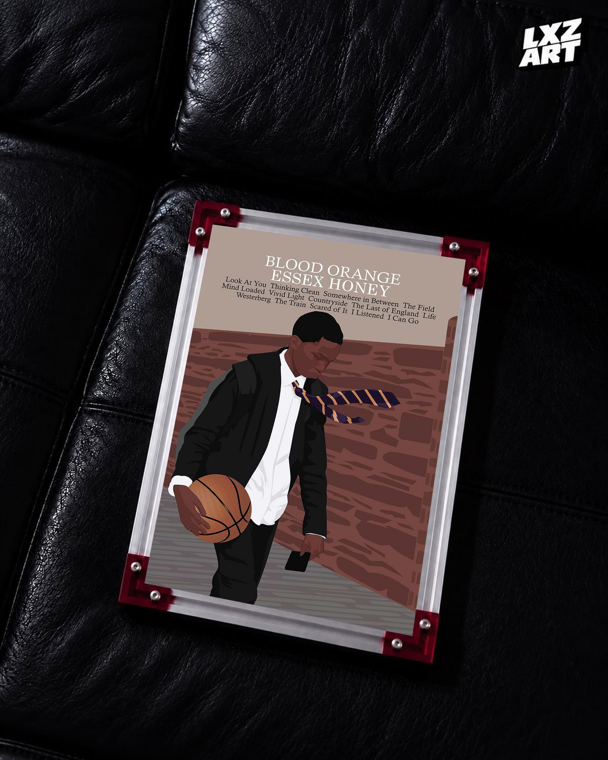Blood Orange Essex Honey illustrated tracklist poster displayed on a black leather sofa in the red-corner frame; unframed print, frame not included