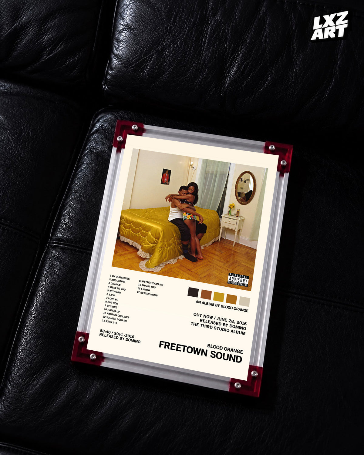 Blood Orange Freetown Sound cream palette tracklist poster displayed on a black leather sofa in the red-corner frame; unframed print, frame not included