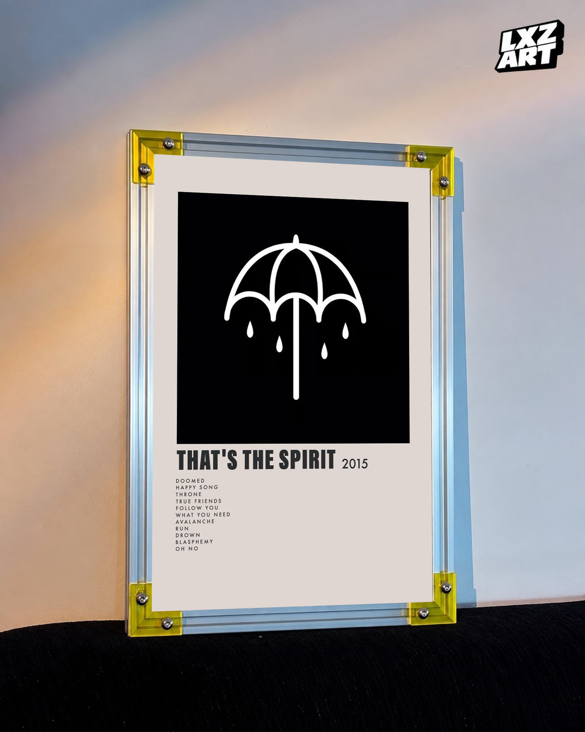 Bring Me The Horizon That's the Spirit umbrella tracklist poster displayed against a warm wall in a yellow-corner frame; unframed print, frame not included