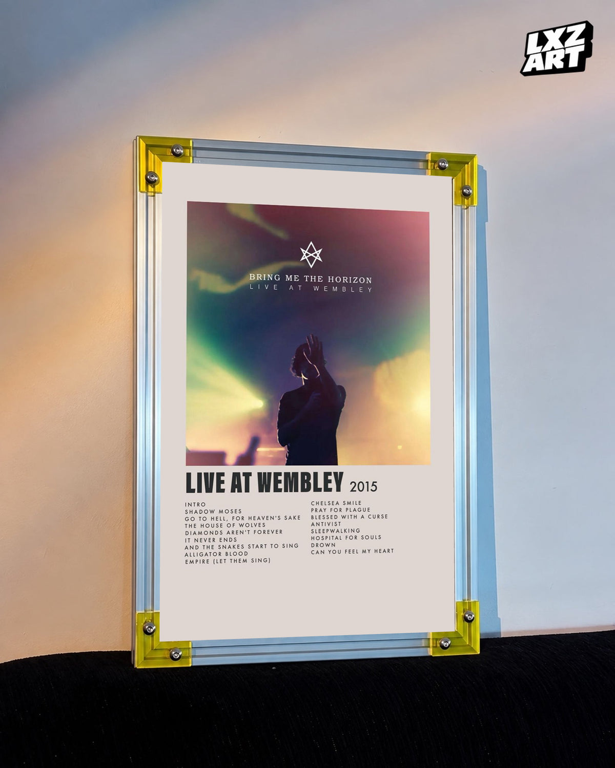 Bring Me The Horizon Live at Wembley concert tracklist poster displayed against a warm wall in a yellow-corner frame; unframed print, frame not included
