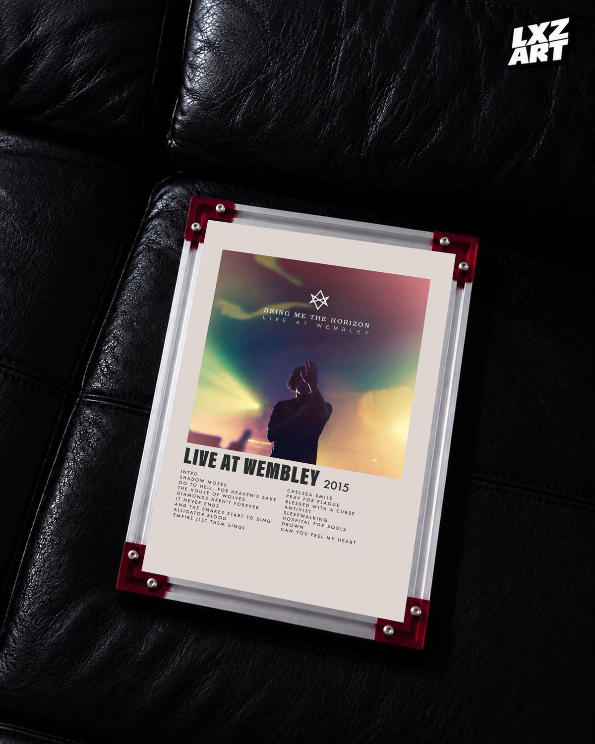 Bring Me The Horizon Live at Wembley concert tracklist poster displayed on a black leather sofa in a red-corner frame; unframed print, frame not included