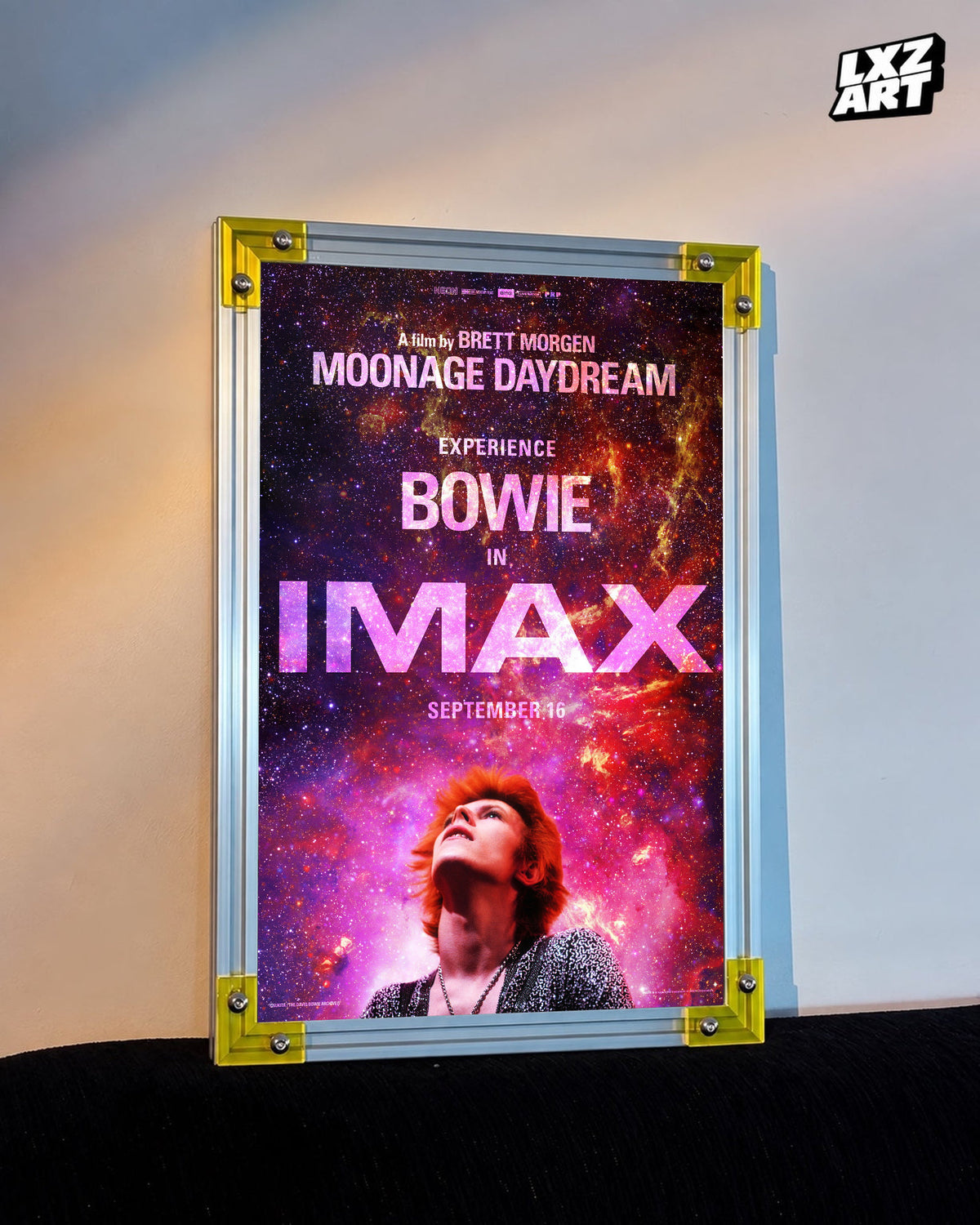 David Bowie Moonage Daydream IMAX Galaxy poster displayed on warm wall with yellow frame corners; frame not included
