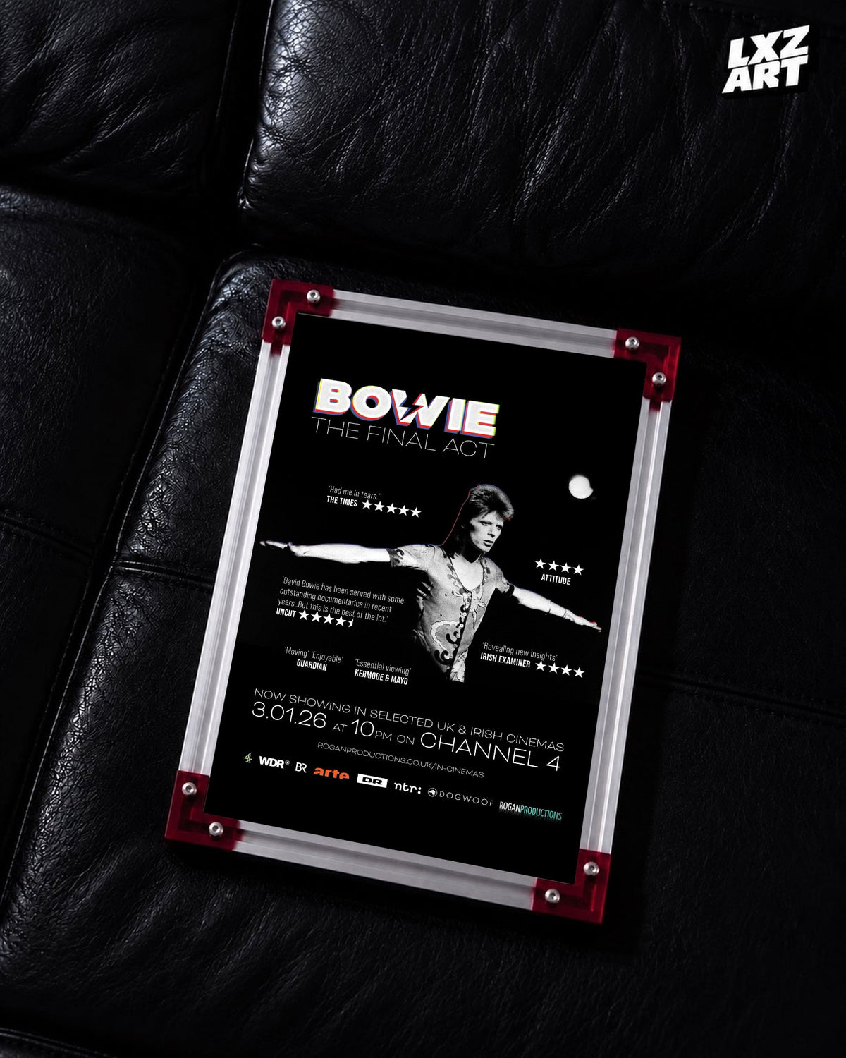 David Bowie The Final Act Stage Portrait poster displayed on black leather sofa with red frame corners; frame not included
