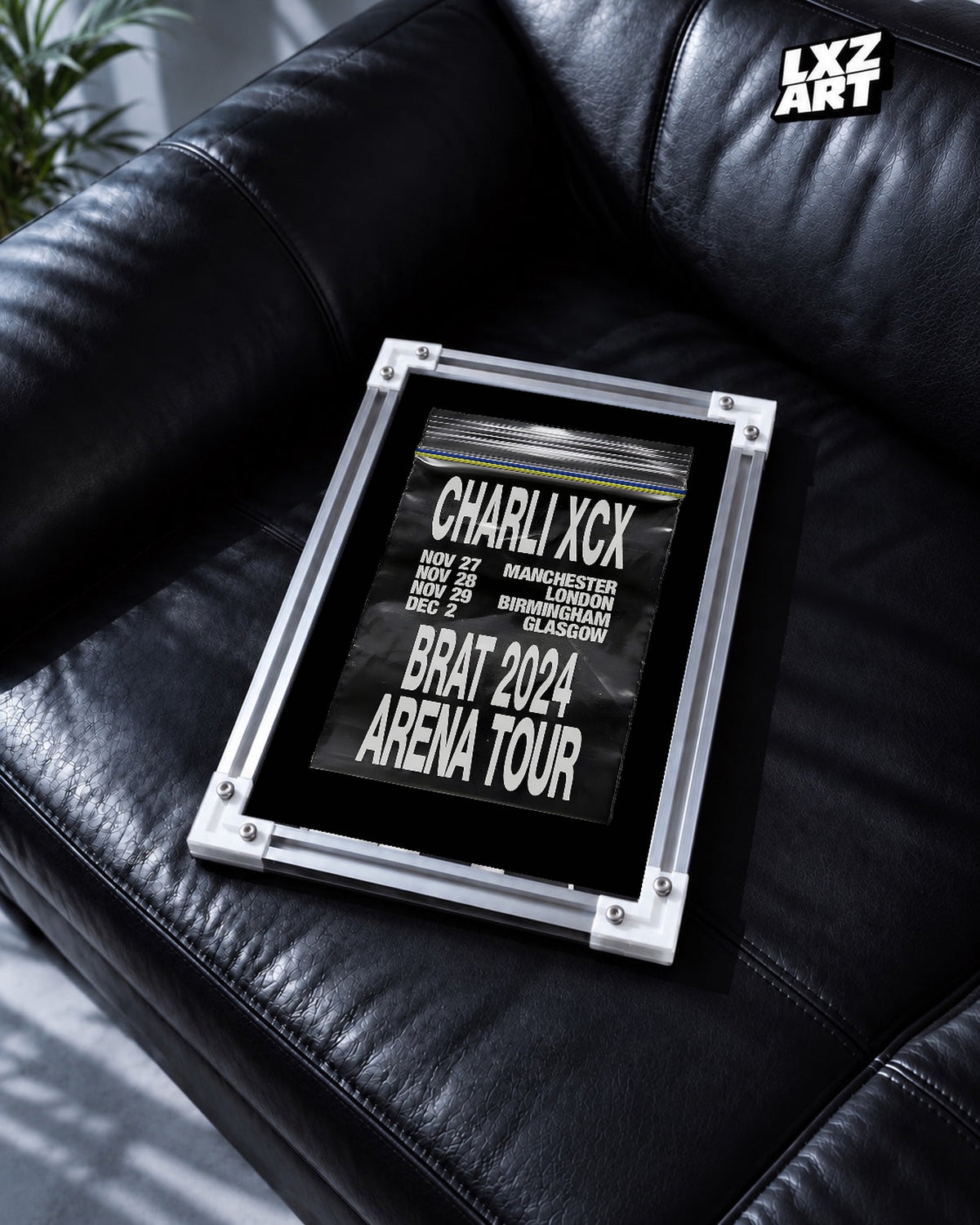 Charli xcx Brat 2024 UK Arena Tour Zip Bag unframed poster shown in the black leather sofa display.