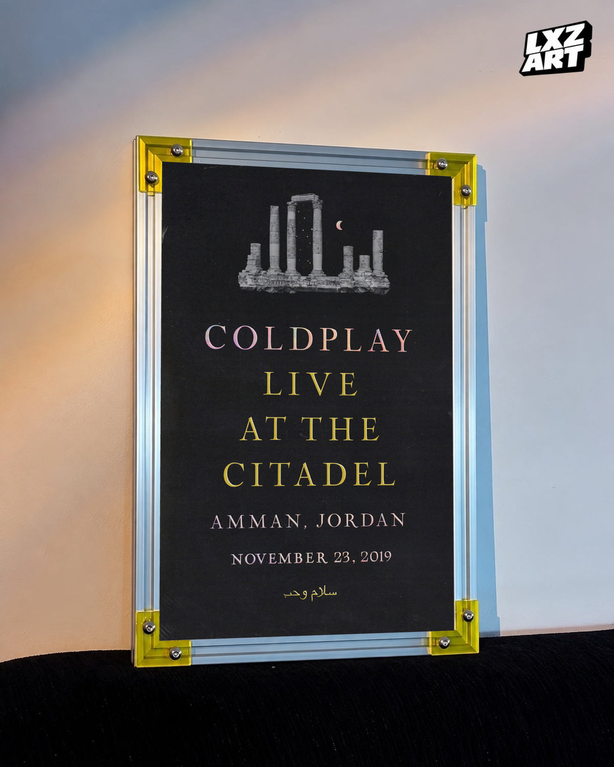Coldplay Everyday Life Live at the Citadel Poster displayed against a warm wall in a yellow-corner frame; unframed print, frame not included