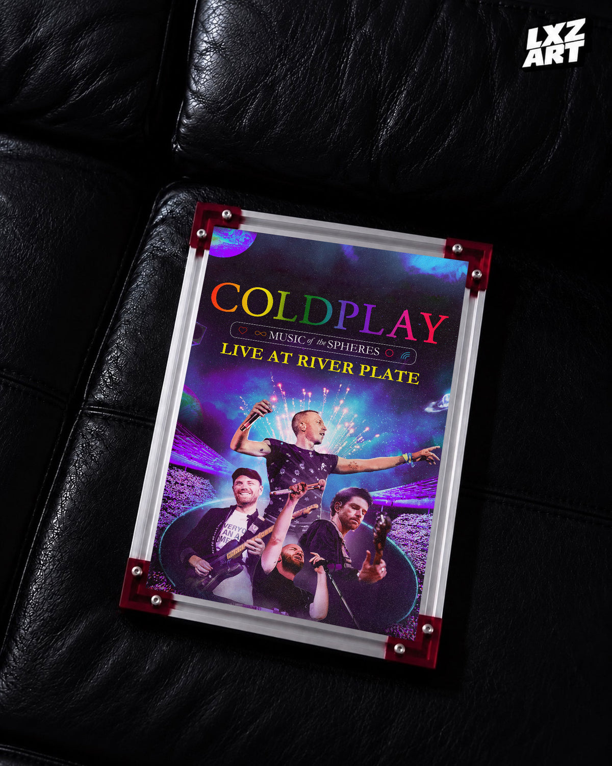 Coldplay Music of the Spheres Live at River Plate Poster displayed on a black leather sofa in a red-corner frame; unframed print, frame not included