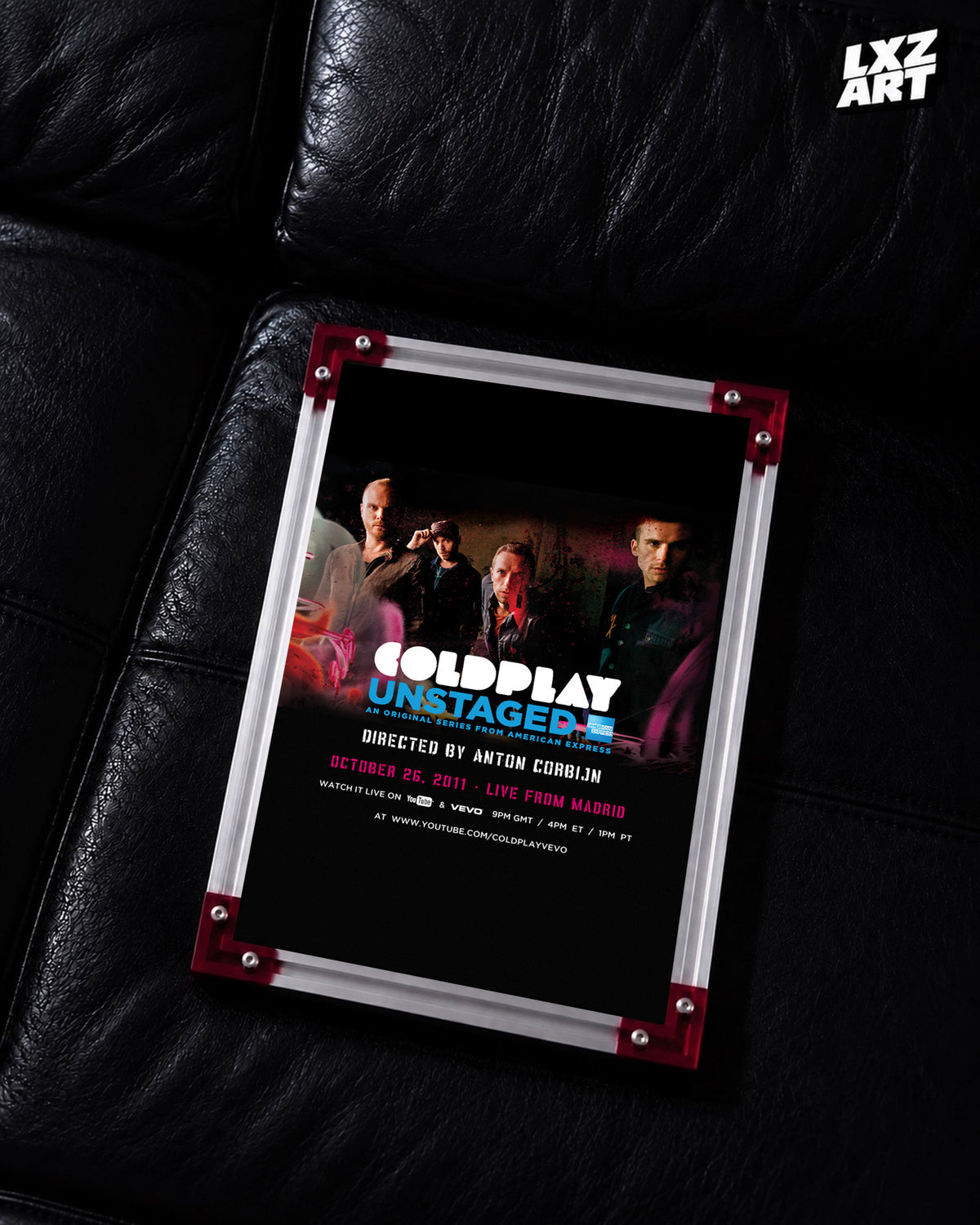 Coldplay Unstaged Live From Madrid 2011 Poster displayed on a black leather sofa in a red-corner frame; unframed print, frame not included
