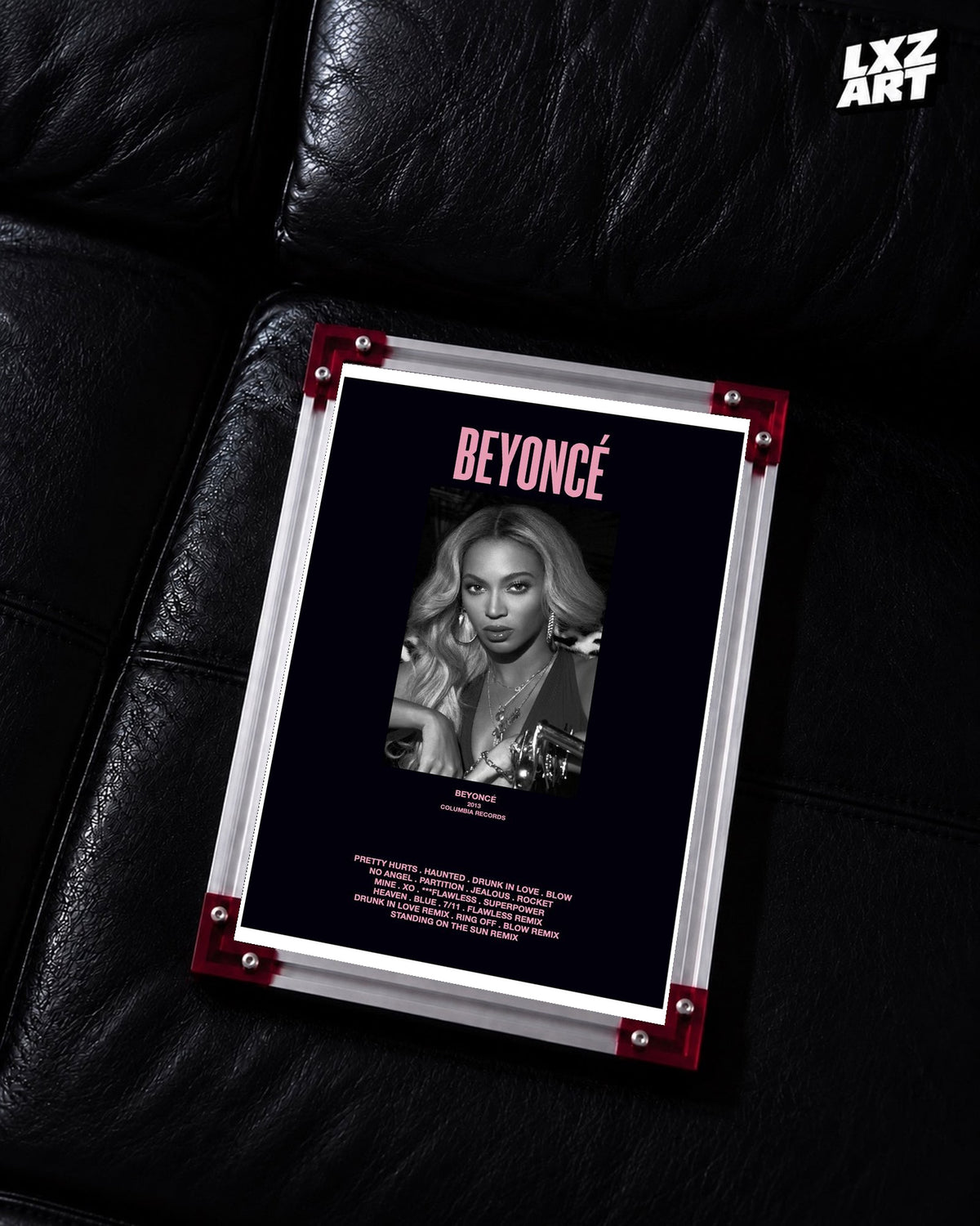 Beyoncé Beyoncé tracklist poster displayed on a black leather sofa in a red corner frame; unframed print, frame not included