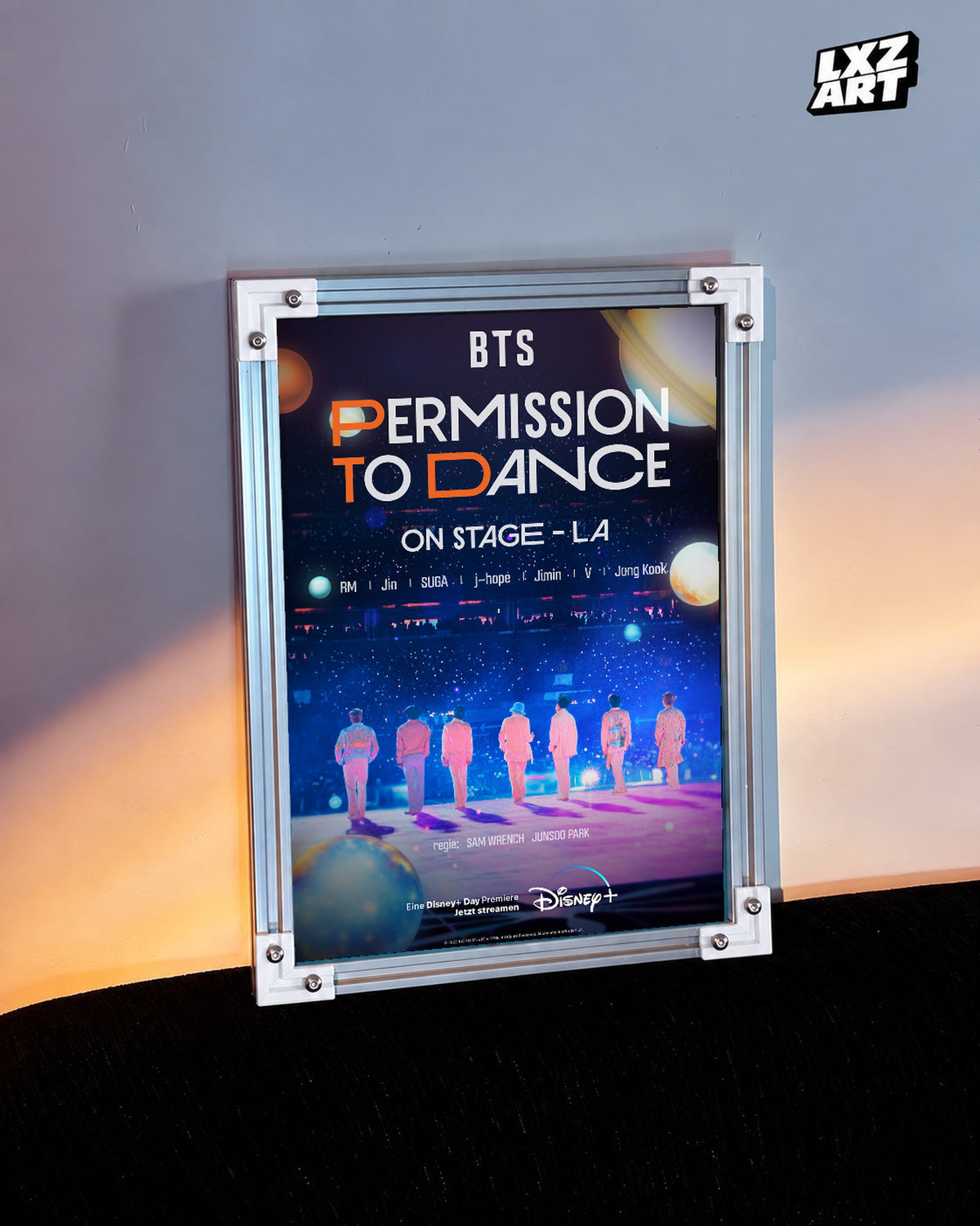 BTS Permission to Dance On Stage LA poster in the LXZART warm-lit wall display. Unframed print; frame shown for display only.