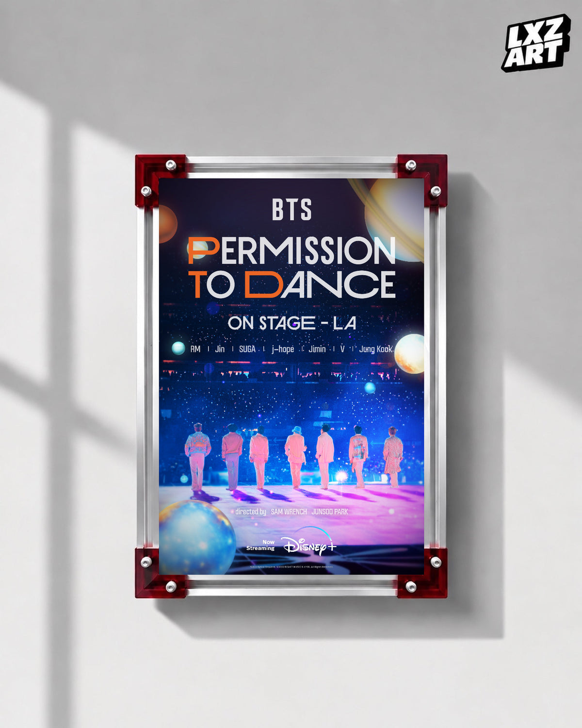 BTS Permission to Dance on Stage LA concert film poster displayed on a gray wall in a red-corner frame; unframed print, frame not included