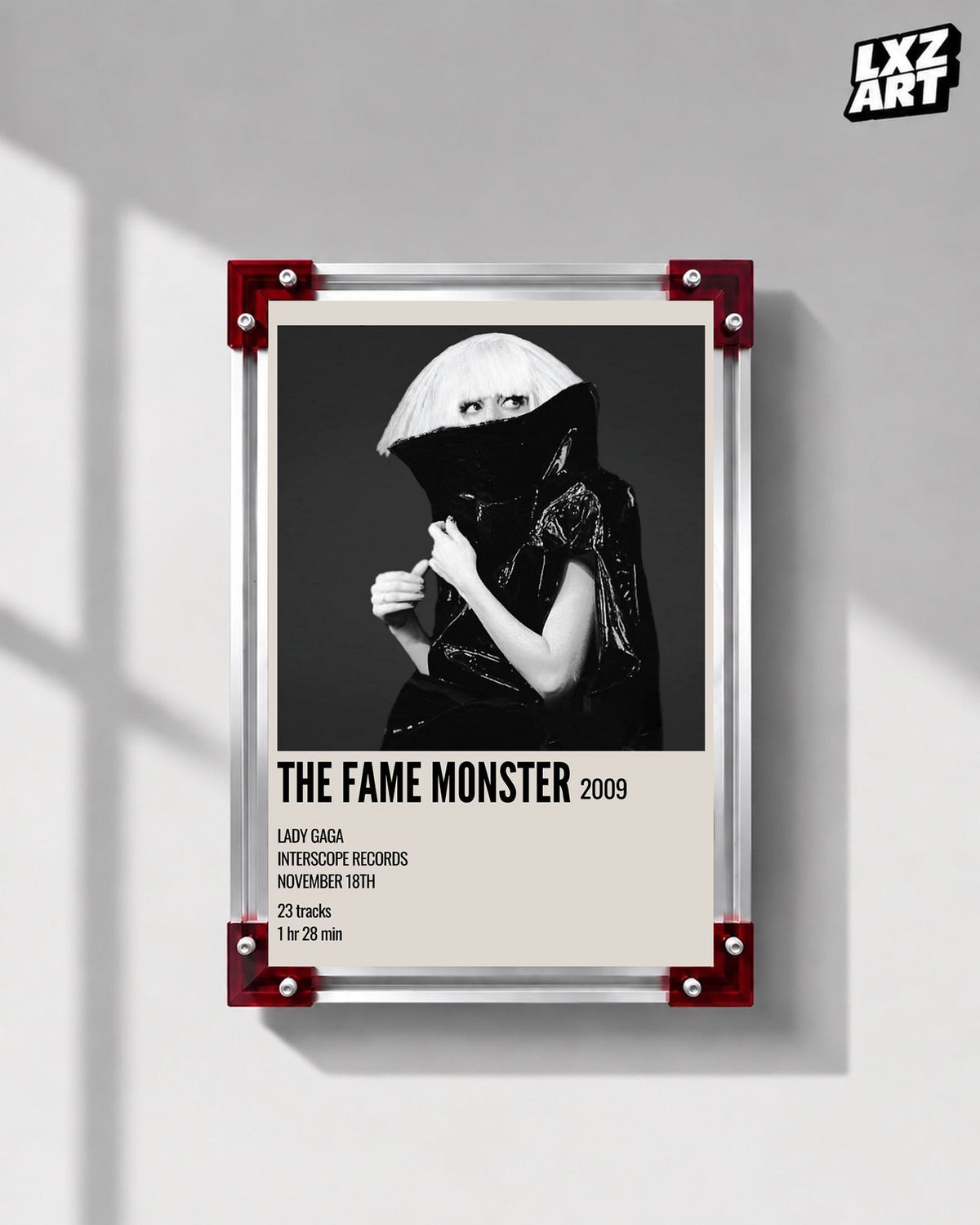Lady Gaga The Fame Monster album cover poster displayed on a gray wall in a red corner frame; unframed print, frame not included