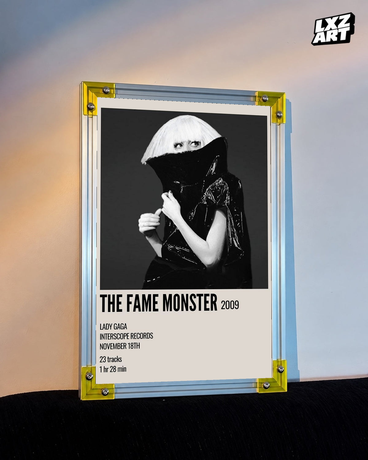 Lady Gaga The Fame Monster album cover poster displayed against a warm wall in a yellow corner frame; unframed print, frame not included