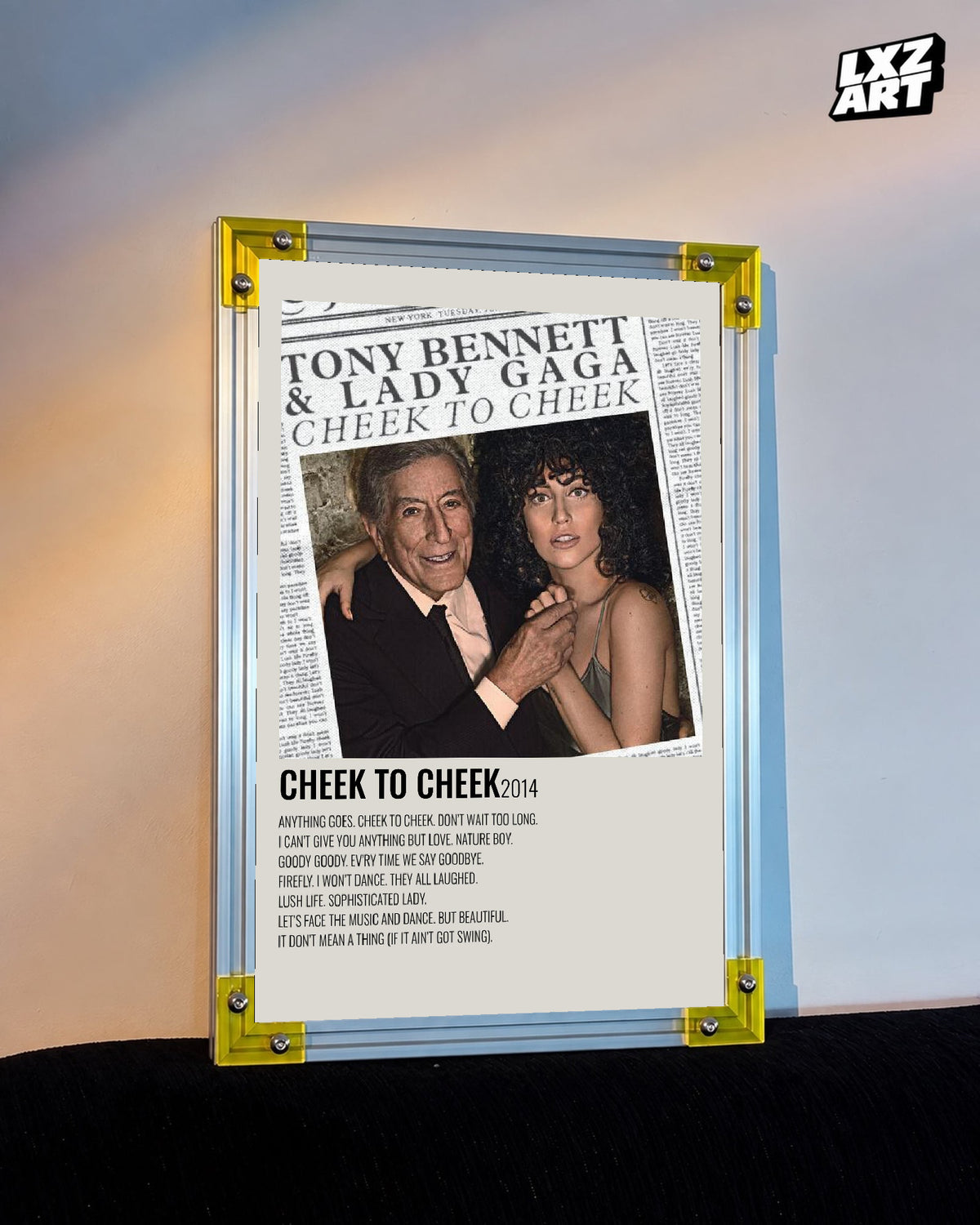 Lady Gaga & Tony Bennett Cheek to Cheek tracklist poster displayed against a warm wall in a yellow corner frame; unframed print, frame not included