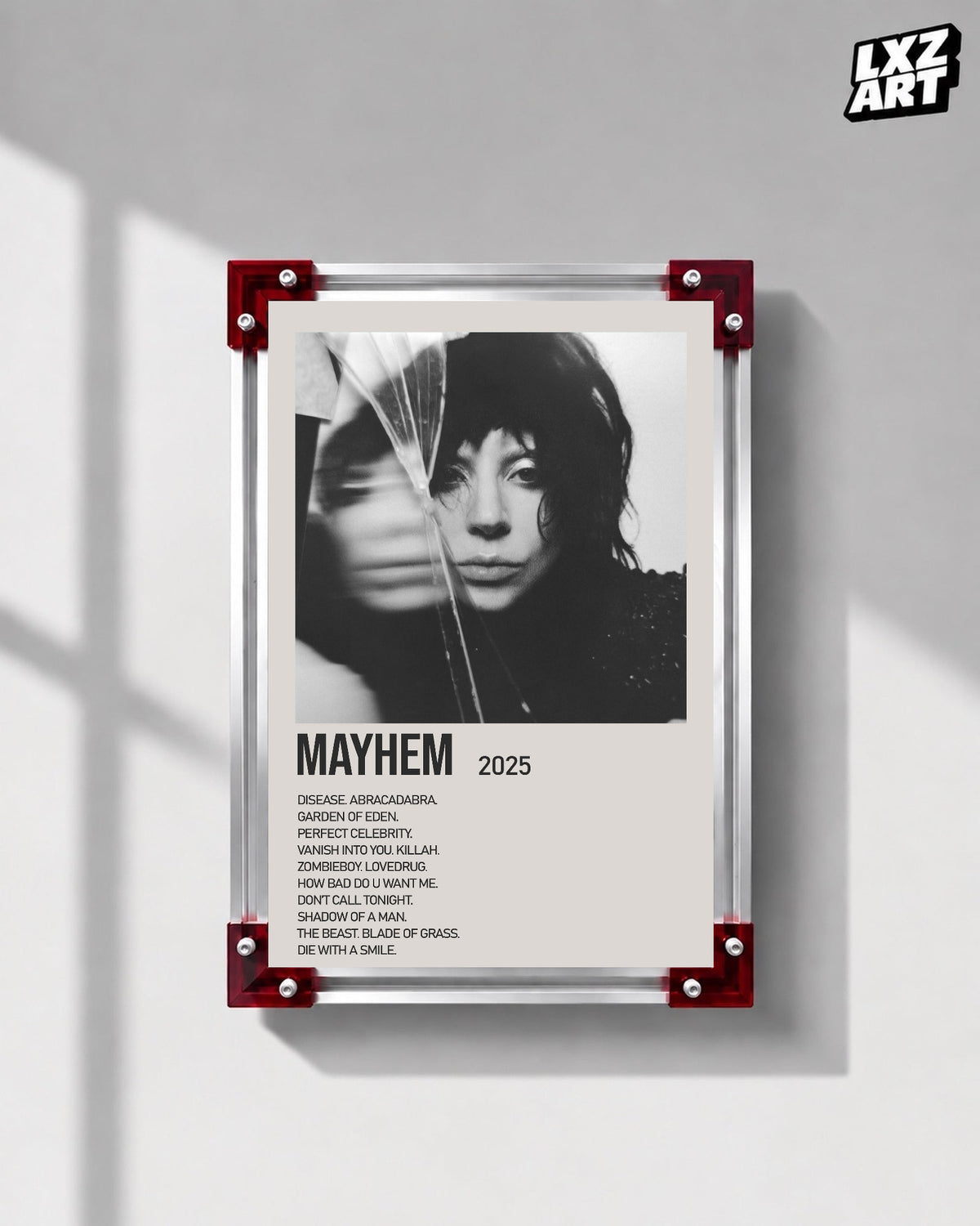 Lady Gaga Mayhem tracklist poster displayed on a gray wall in a red corner frame; unframed print, frame not included