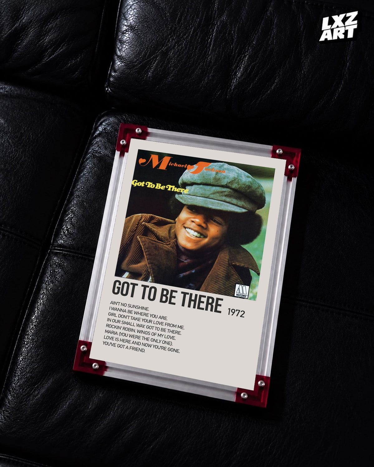 Michael Jackson Got to Be There tracklist poster displayed on a black leather sofa in a red corner frame; unframed print, frame not included