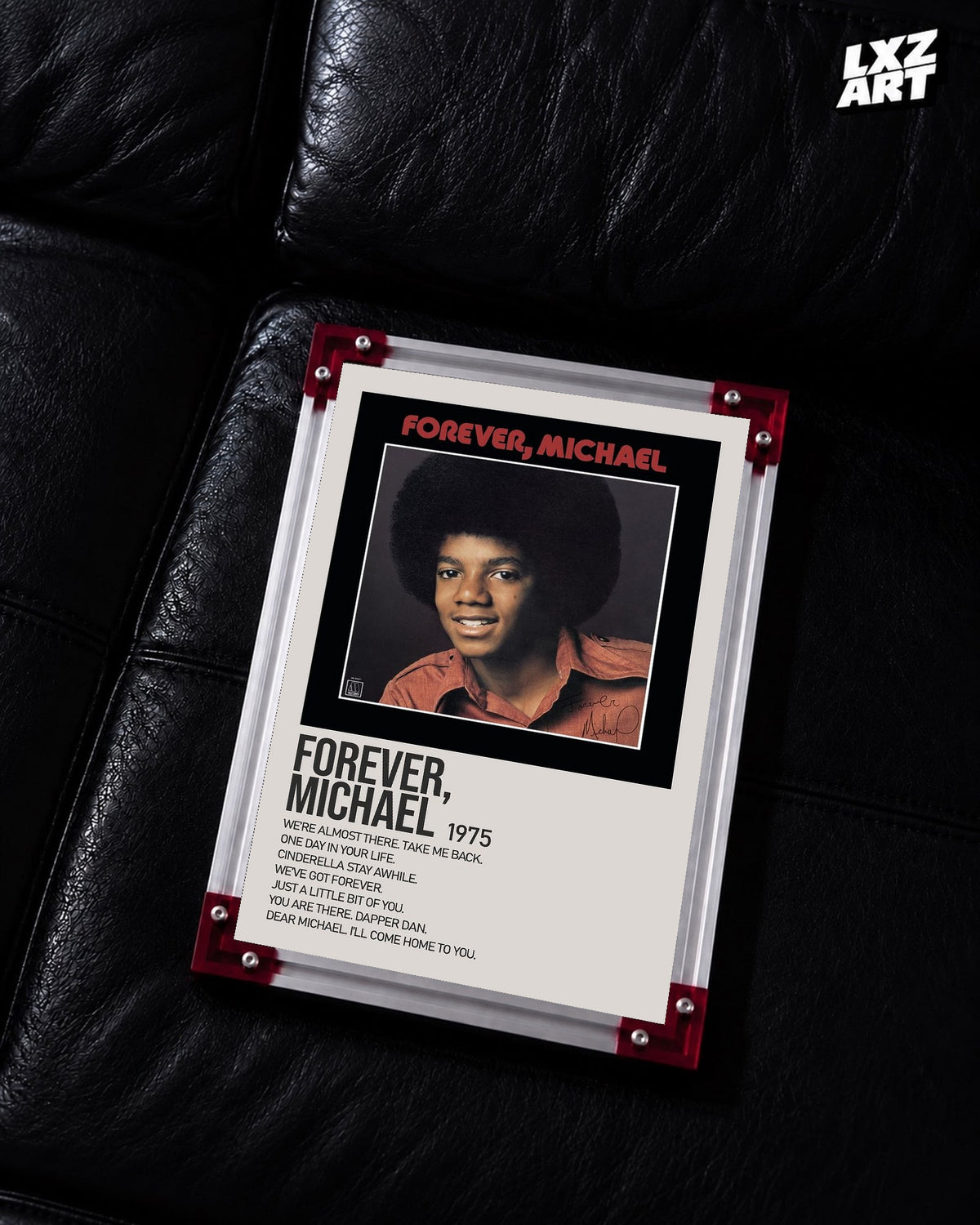 Michael Jackson Forever, Michael tracklist poster displayed on a black leather sofa in a red corner frame; unframed print, frame not included