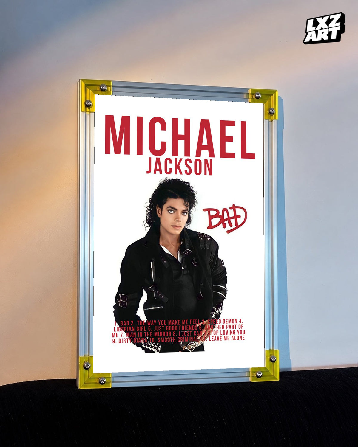 Michael Jackson Bad Red Typography tracklist poster displayed against a warm wall in a yellow corner frame; unframed print, frame not included