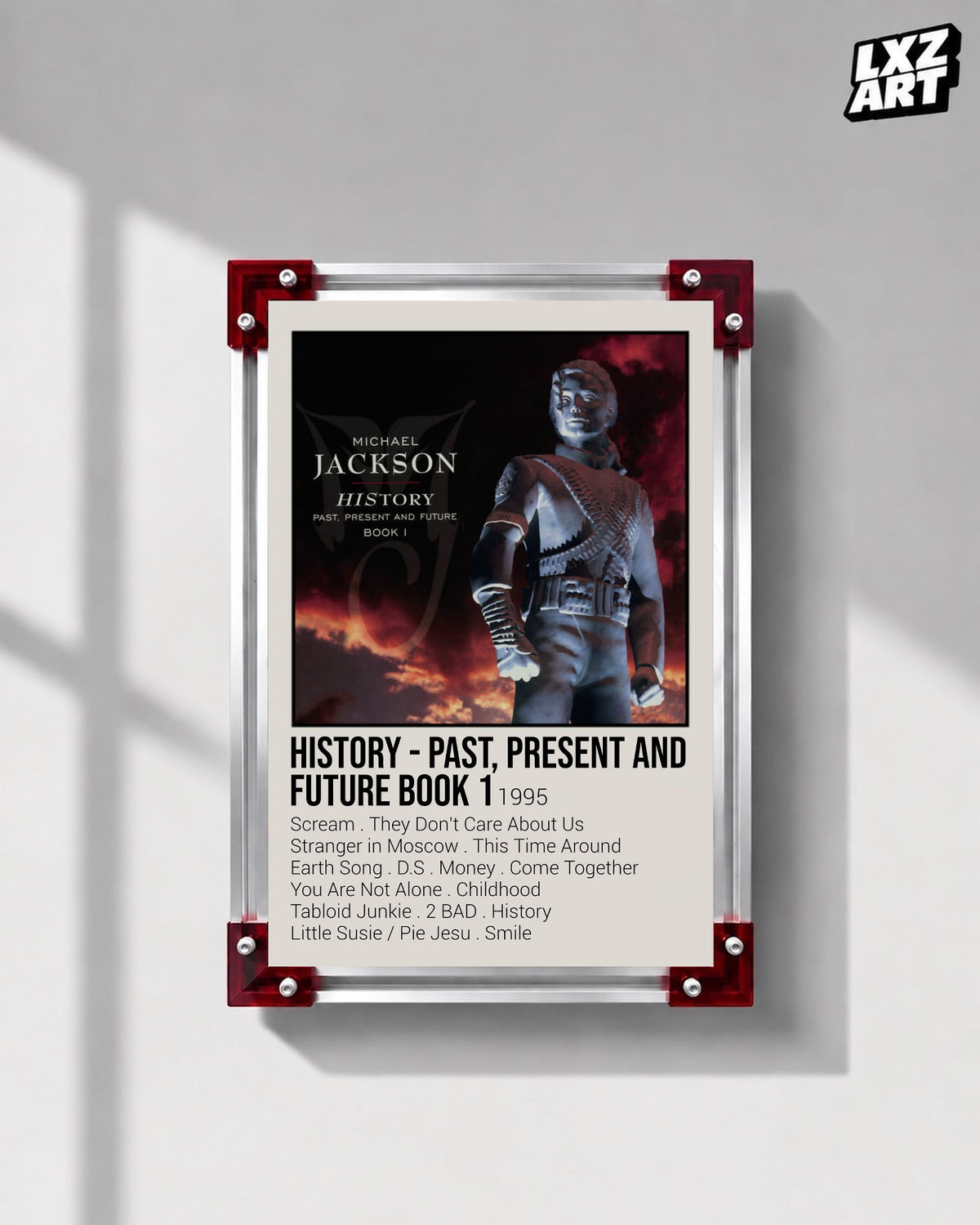 Michael Jackson HIStory Past, Present and Future Book I tracklist poster displayed on a gray wall in a red corner frame; unframed print, frame not included