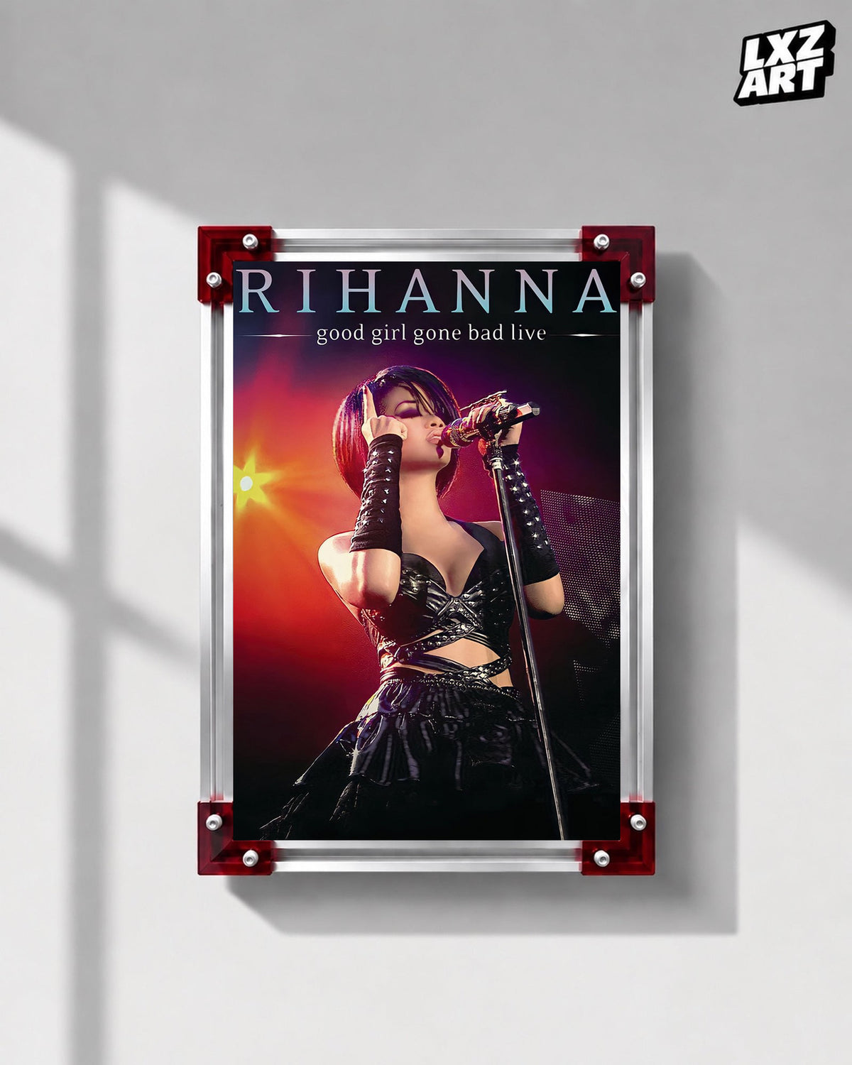 Rihanna Good Girl Gone Bad Live concert film poster displayed on a gray wall in a red corner frame; unframed print, frame not included