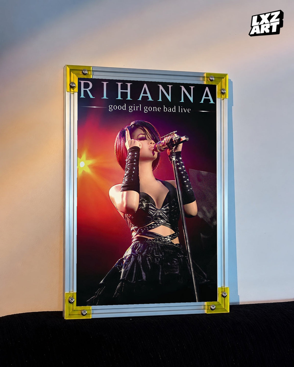 Rihanna Good Girl Gone Bad Live concert film poster displayed against a warm wall in a yellow corner frame; unframed print, frame not included