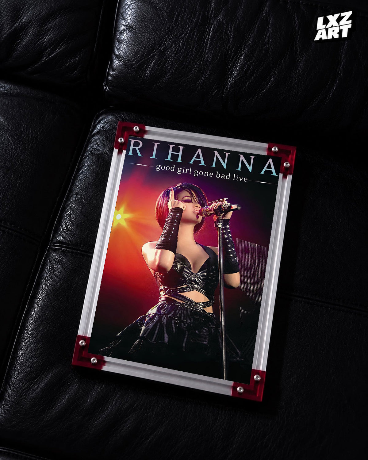 Rihanna Good Girl Gone Bad Live concert film poster displayed on a black leather sofa in a red corner frame; unframed print, frame not included