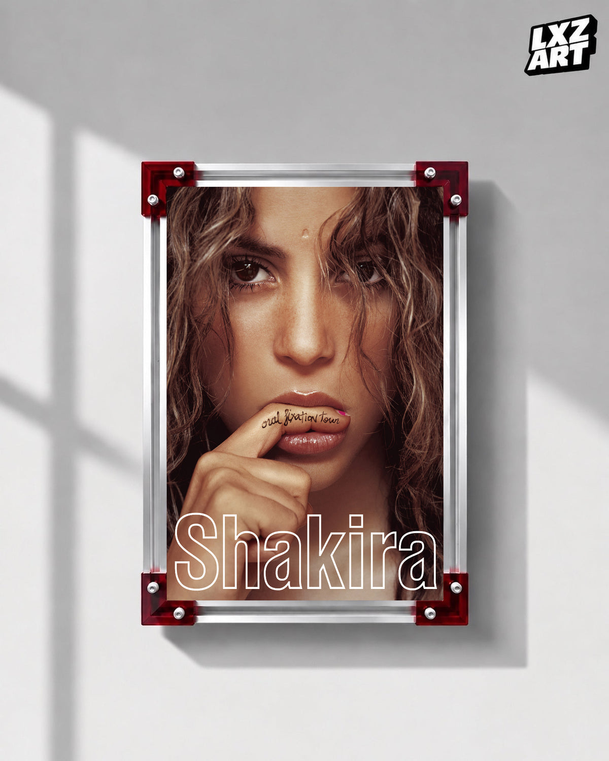 Shakira Oral Fixation Tour concert film poster displayed on a gray wall in a red corner frame; unframed print, frame not included