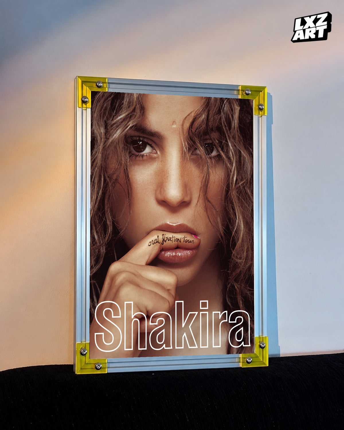 Shakira Oral Fixation Tour concert film poster displayed against a warm wall in a yellow corner frame; unframed print, frame not included
