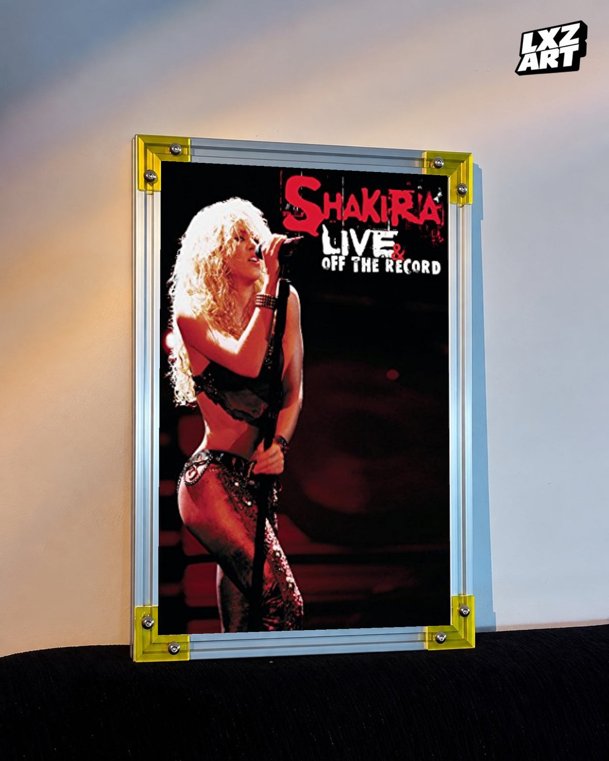 Shakira Live & Off the Record concert film poster displayed against a warm wall in a yellow corner frame; unframed print, frame not included