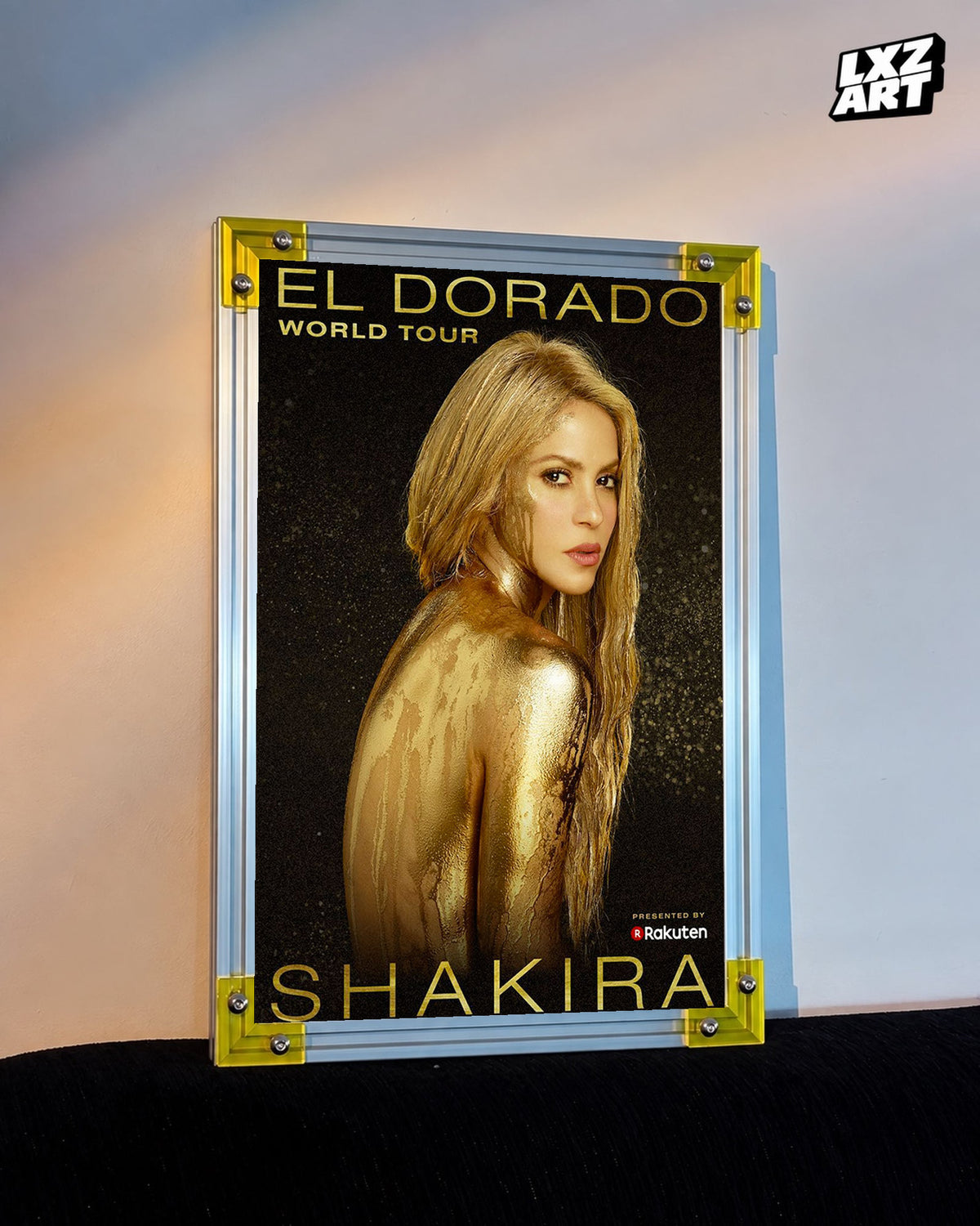Shakira El Dorado World Tour concert tour poster displayed against a warm wall in a yellow corner frame; unframed print, frame not included