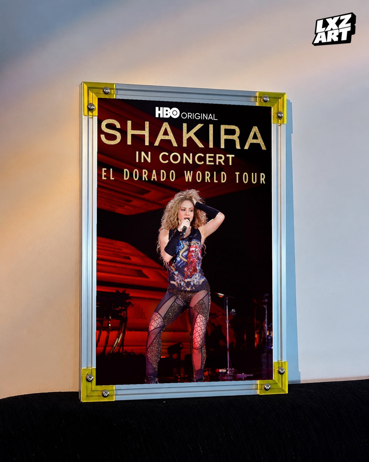 Shakira In Concert: El Dorado World Tour concert film poster displayed against a warm wall in a yellow corner frame; unframed print, frame not included