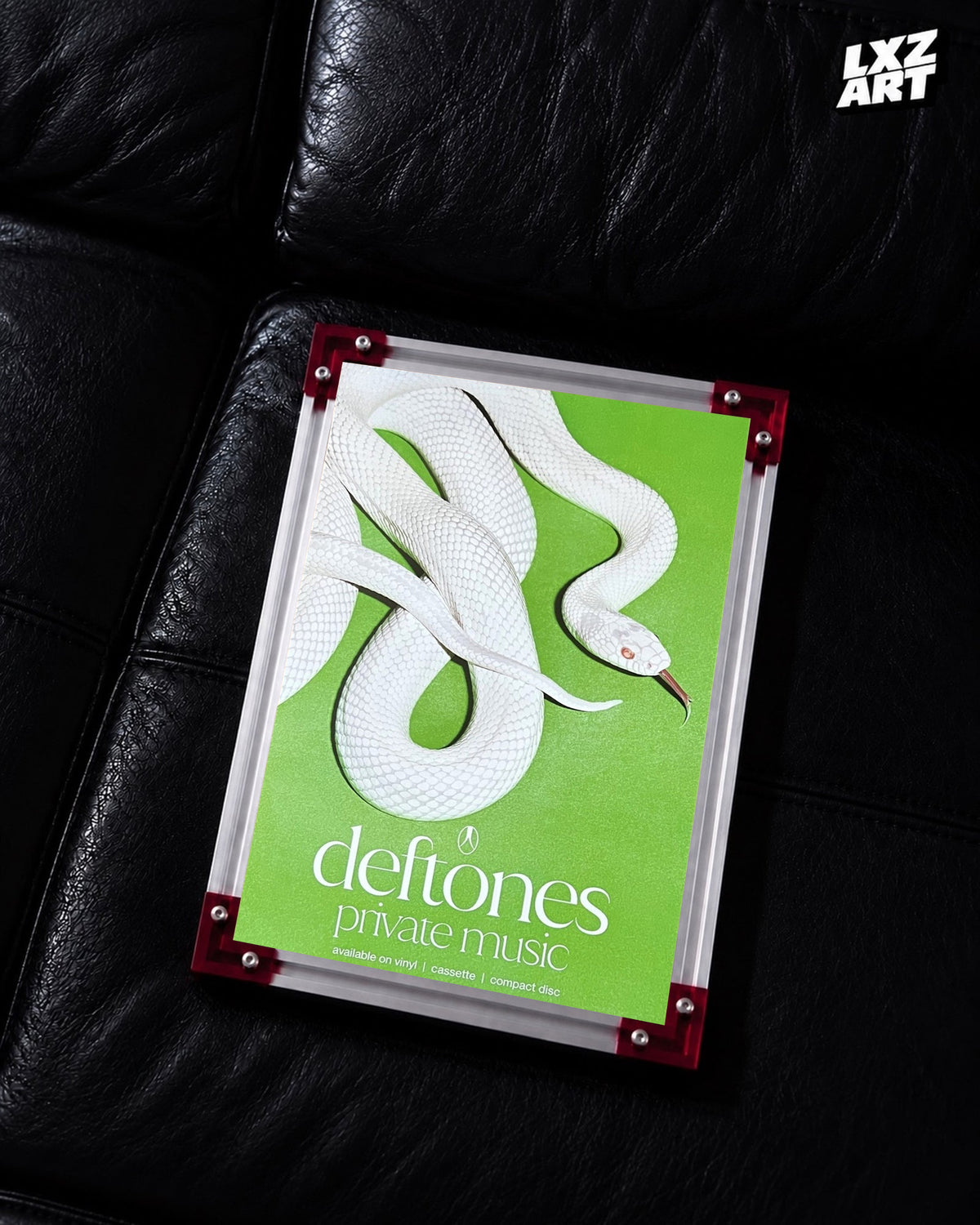 Deftones Private Music White Snake Album Poster displayed on a black leather sofa in a red-corner frame; unframed print, frame not included
