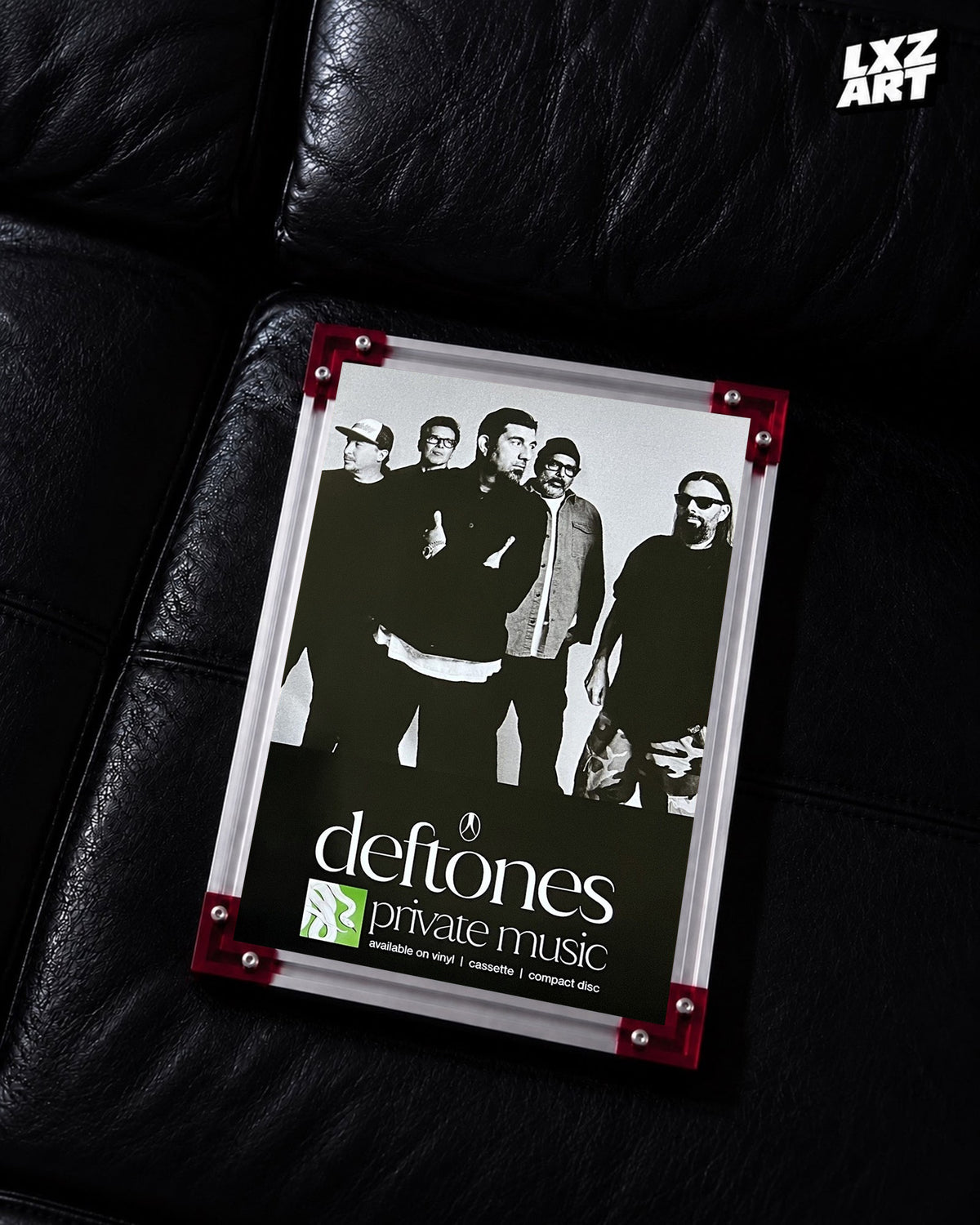 Deftones Private Music Monochrome Band Album Poster displayed on a black leather sofa in a red-corner frame; unframed print, frame not included