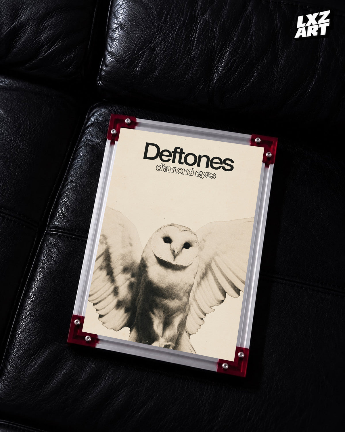 Deftones Diamond Eyes Cream Owl Album Poster displayed on a black leather sofa in a red-corner frame; unframed print, frame not included