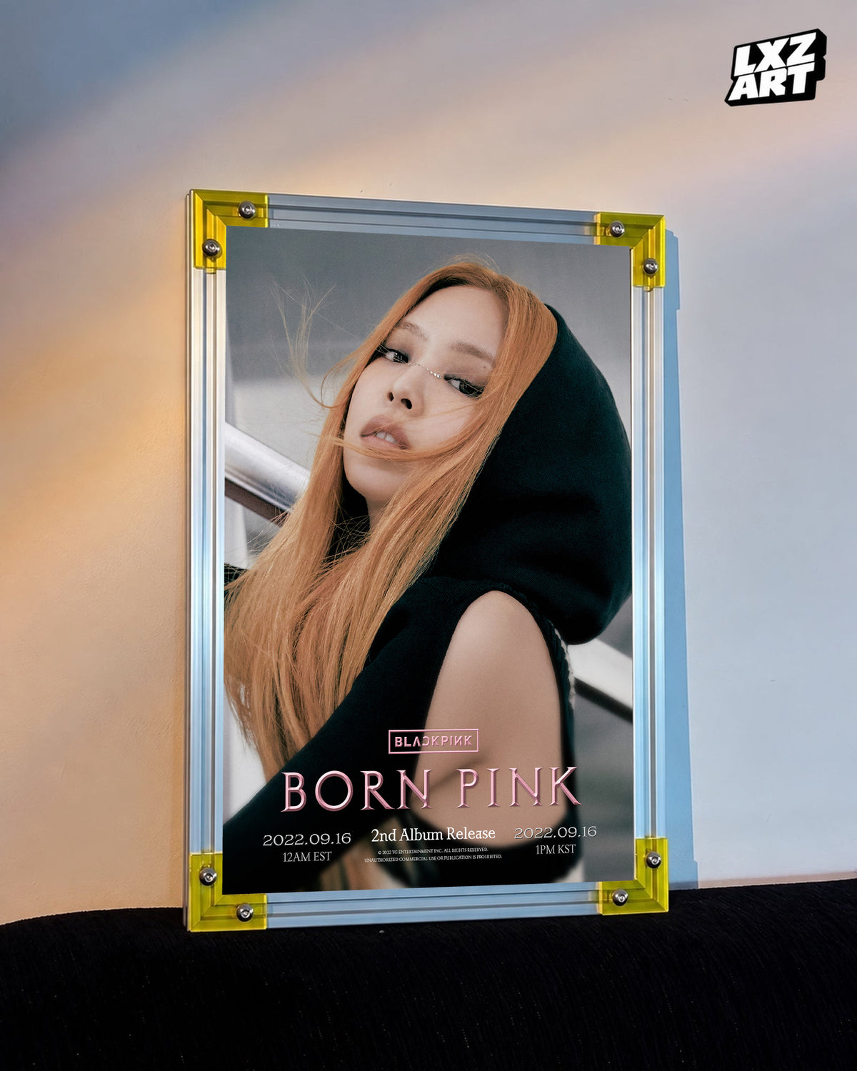 JENNIE BLACKPINK Born Pink hooded concept poster displayed against a warm wall in a yellow-corner frame; unframed print, frame not included