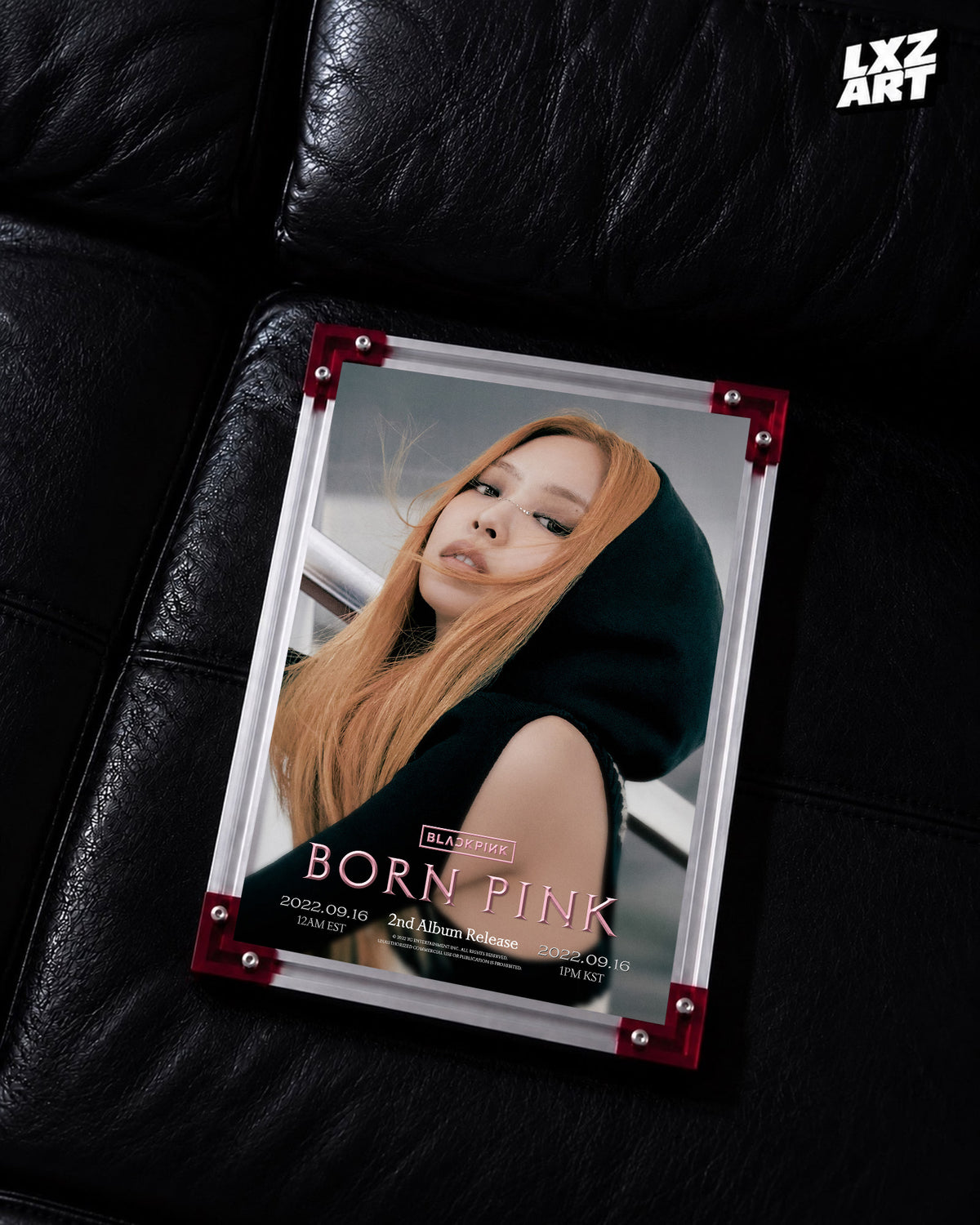 JENNIE BLACKPINK Born Pink hooded concept poster displayed on a black leather sofa in a red-corner frame; unframed print, frame not included
