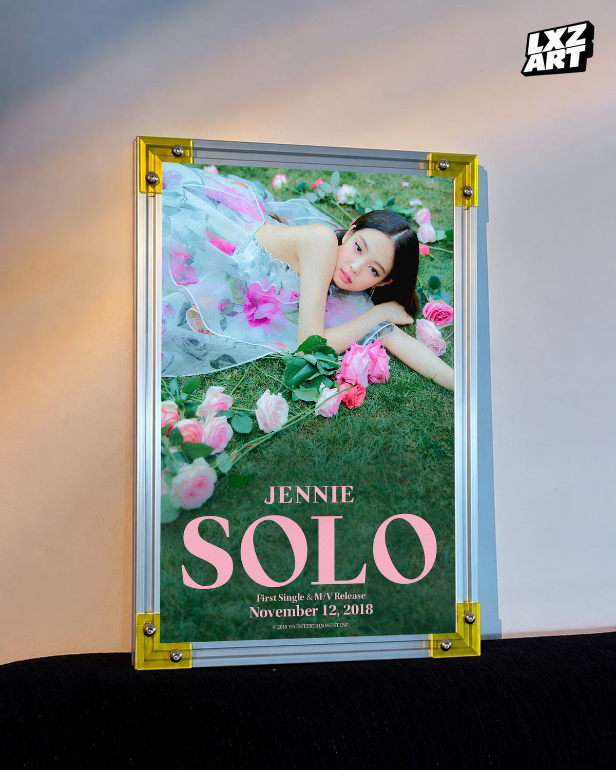 JENNIE SOLO garden teaser poster displayed against a warm wall in a yellow-corner frame; unframed print, frame not included