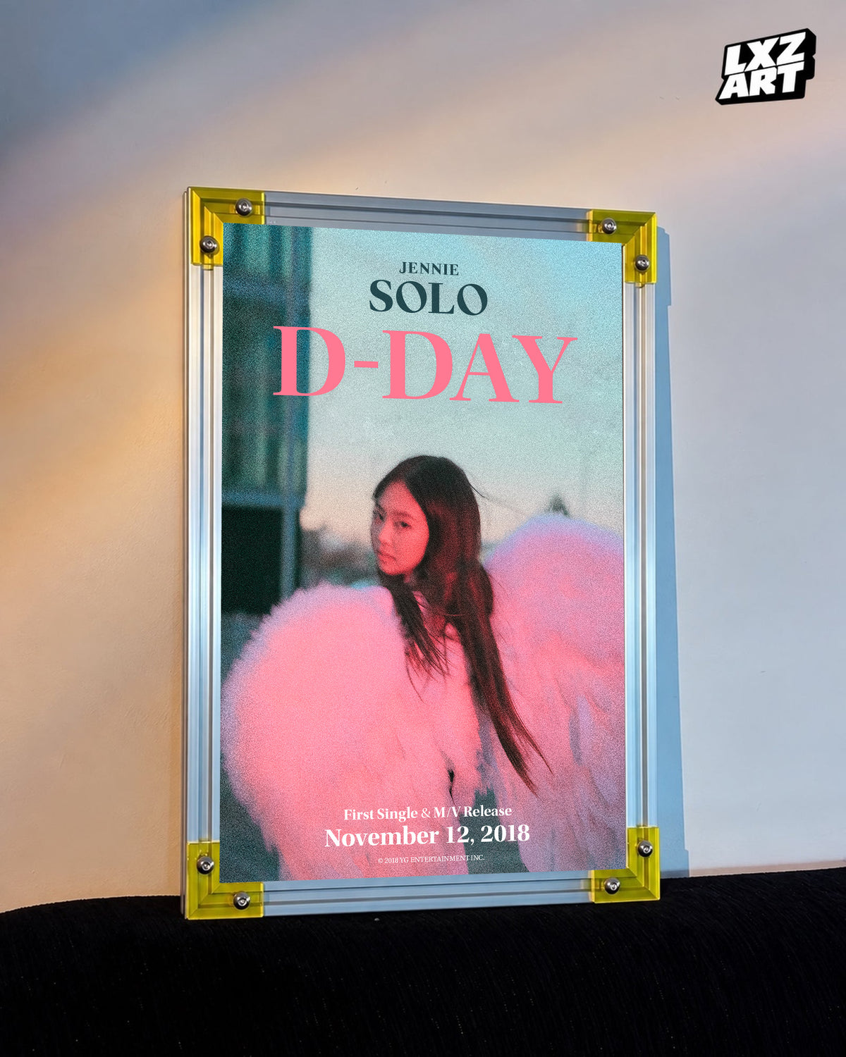 JENNIE SOLO pink d-day poster displayed against a warm wall in a yellow-corner frame; unframed print, frame not included