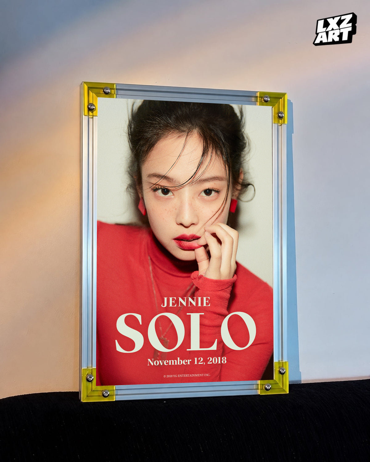 JENNIE SOLO red debut teaser poster displayed against a warm wall in a yellow-corner frame; unframed print, frame not included