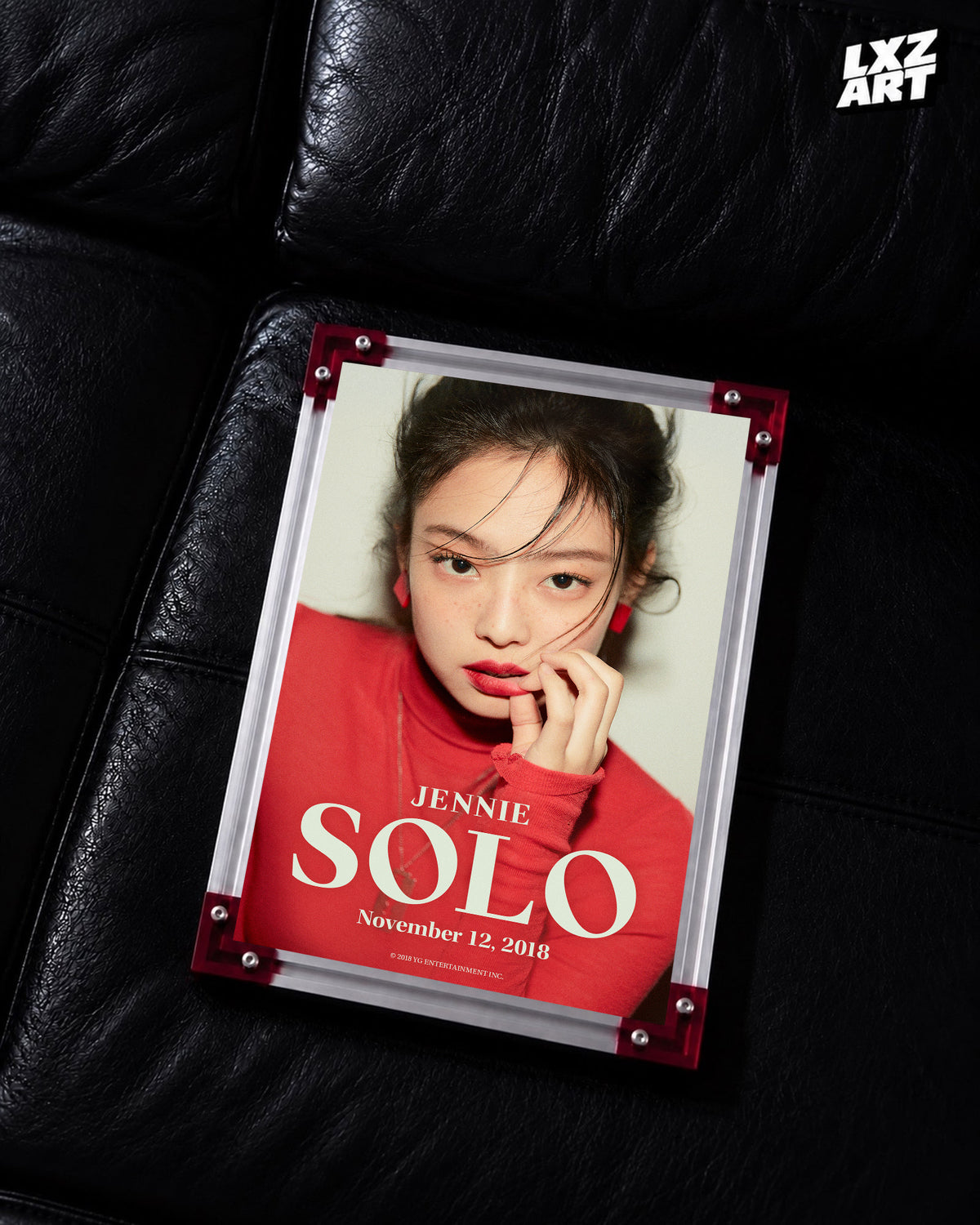 JENNIE SOLO red debut teaser poster displayed on a black leather sofa in a red-corner frame; unframed print, frame not included