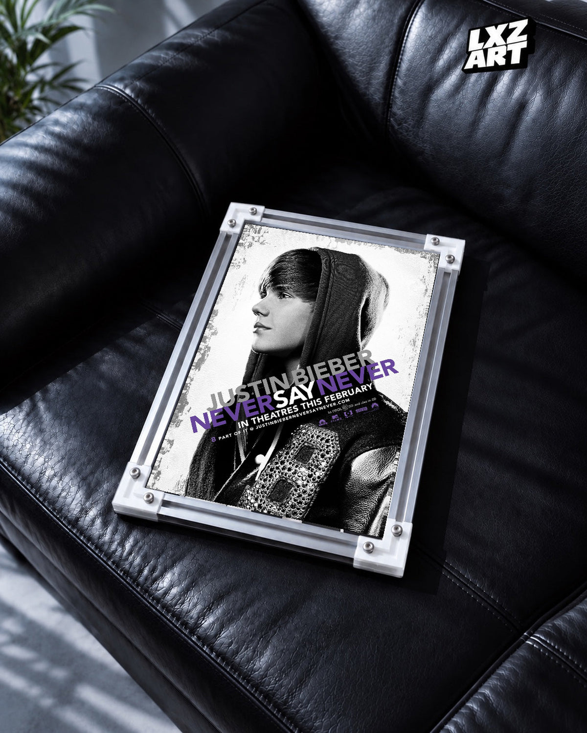 Justin Bieber Never Say Never Black and White Profile Concert Film Poster displayed in a white-corner frame on a black leather sofa. Frame for display only.