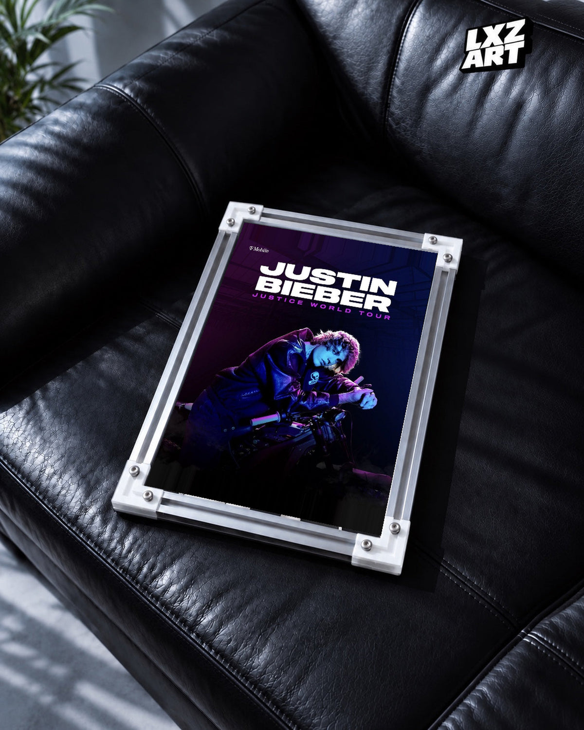 Justin Bieber Justice World Tour Blue Motorcycle Poster displayed in a white-corner frame on a black leather sofa. Frame for display only.