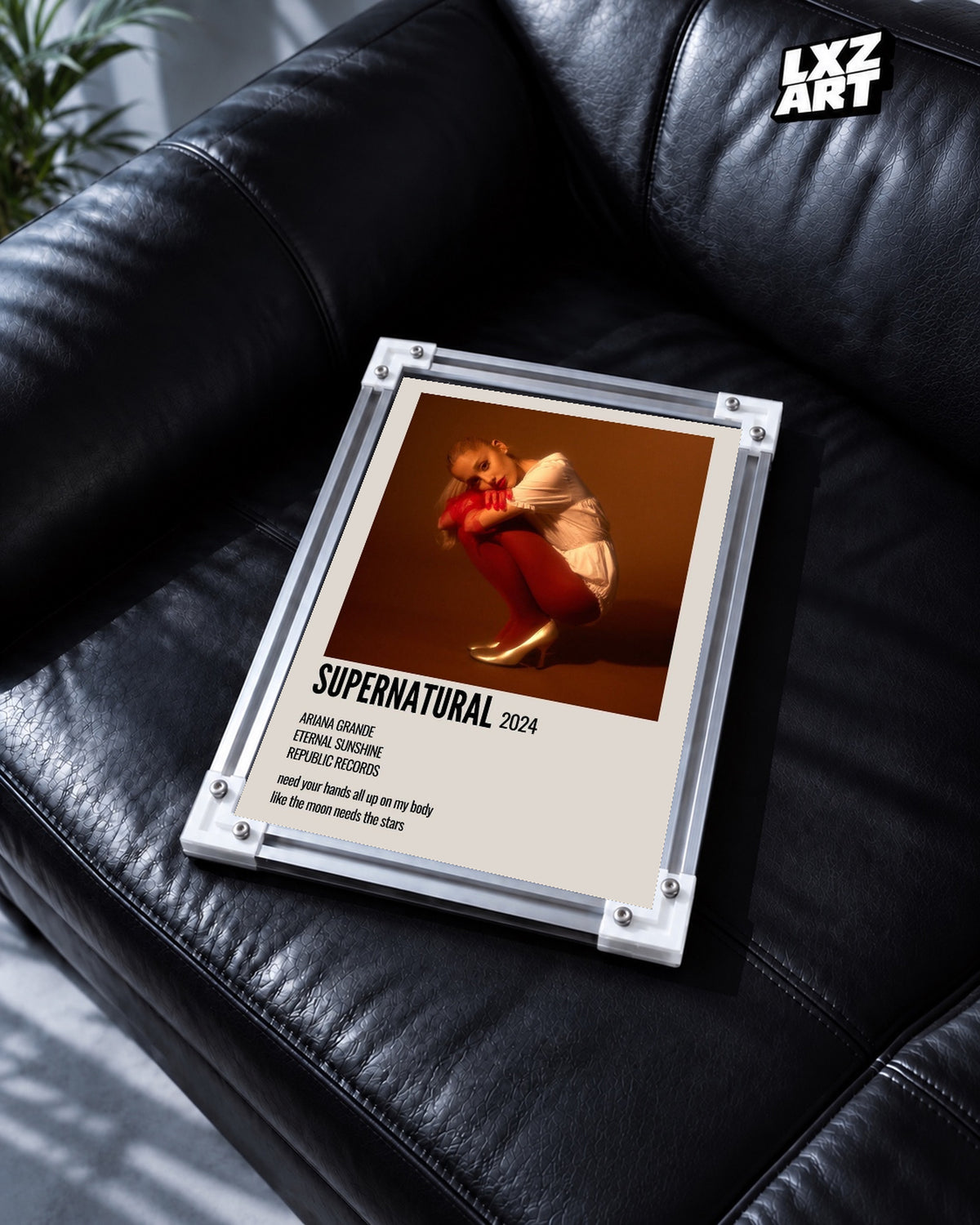 Ariana Grande Supernatural Track Poster — black leather sofa; frame for display only