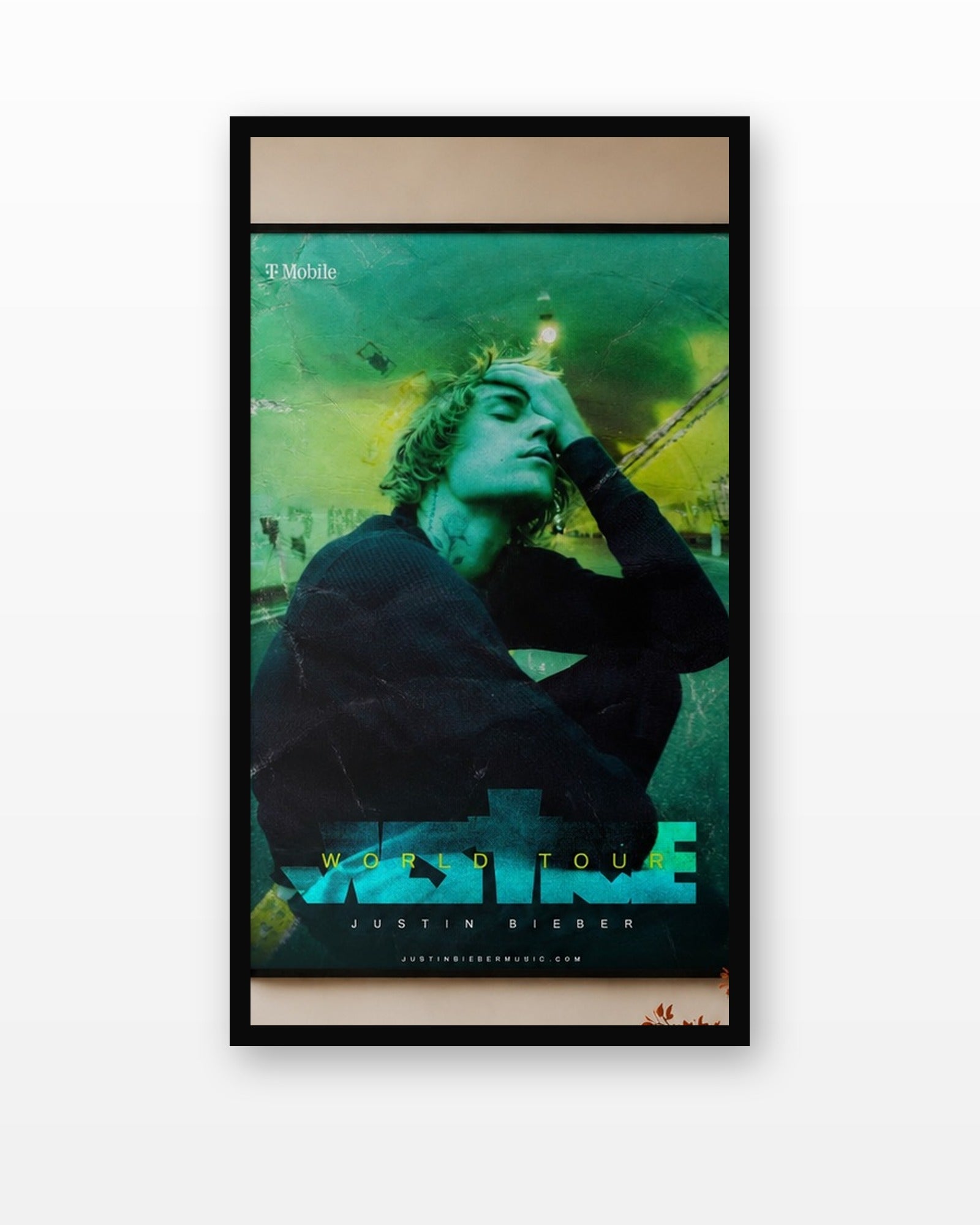 Justin Bieber Justice World Tour Poster in a black frame on a white wall